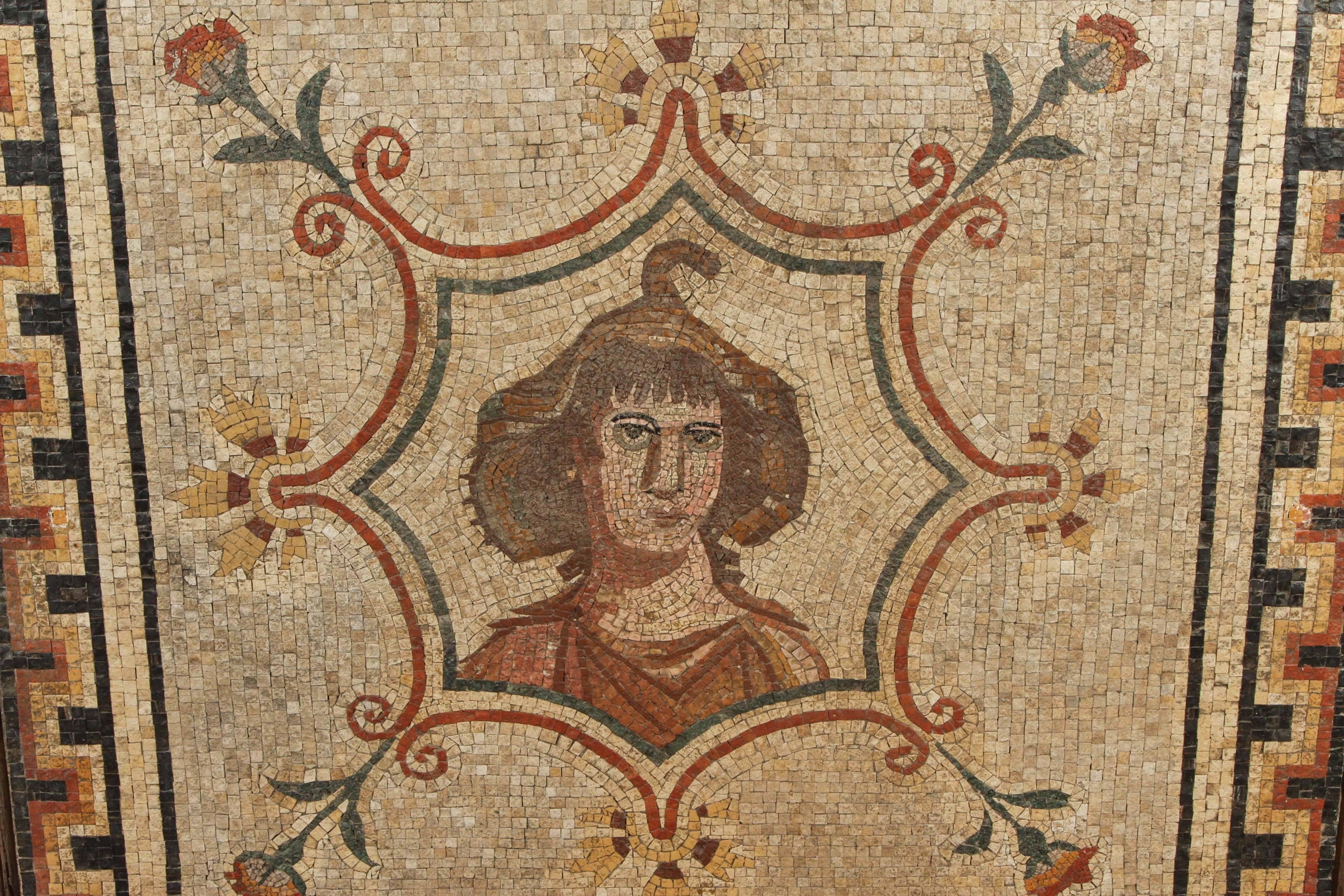 Handmade, Roman, terracotta mosaic featuring a portrait of a scholar surrounded by an octagonal, floral border.