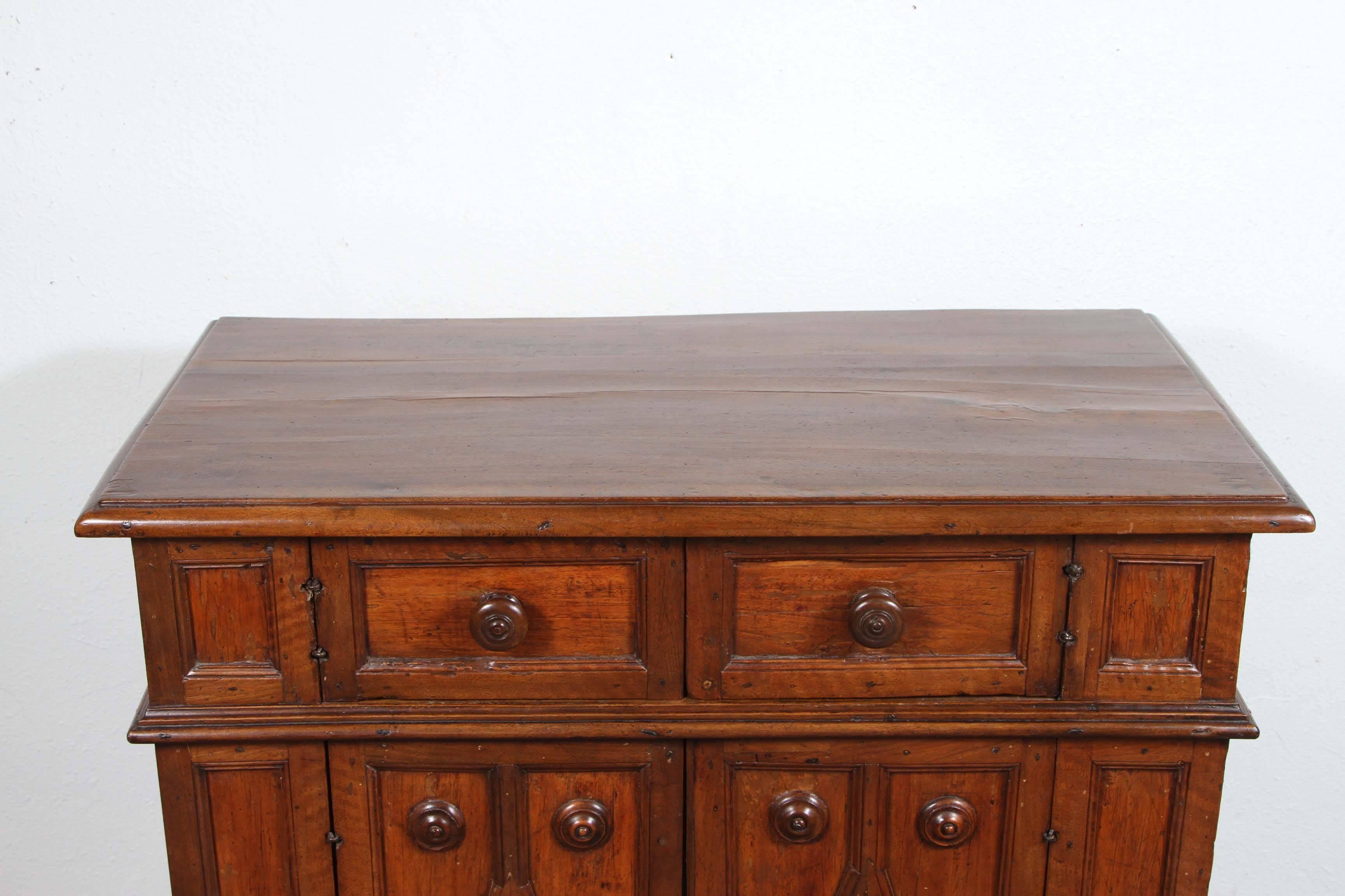 Petite, hand-carved, raised panel, Tuscan credenza on a stepped base.