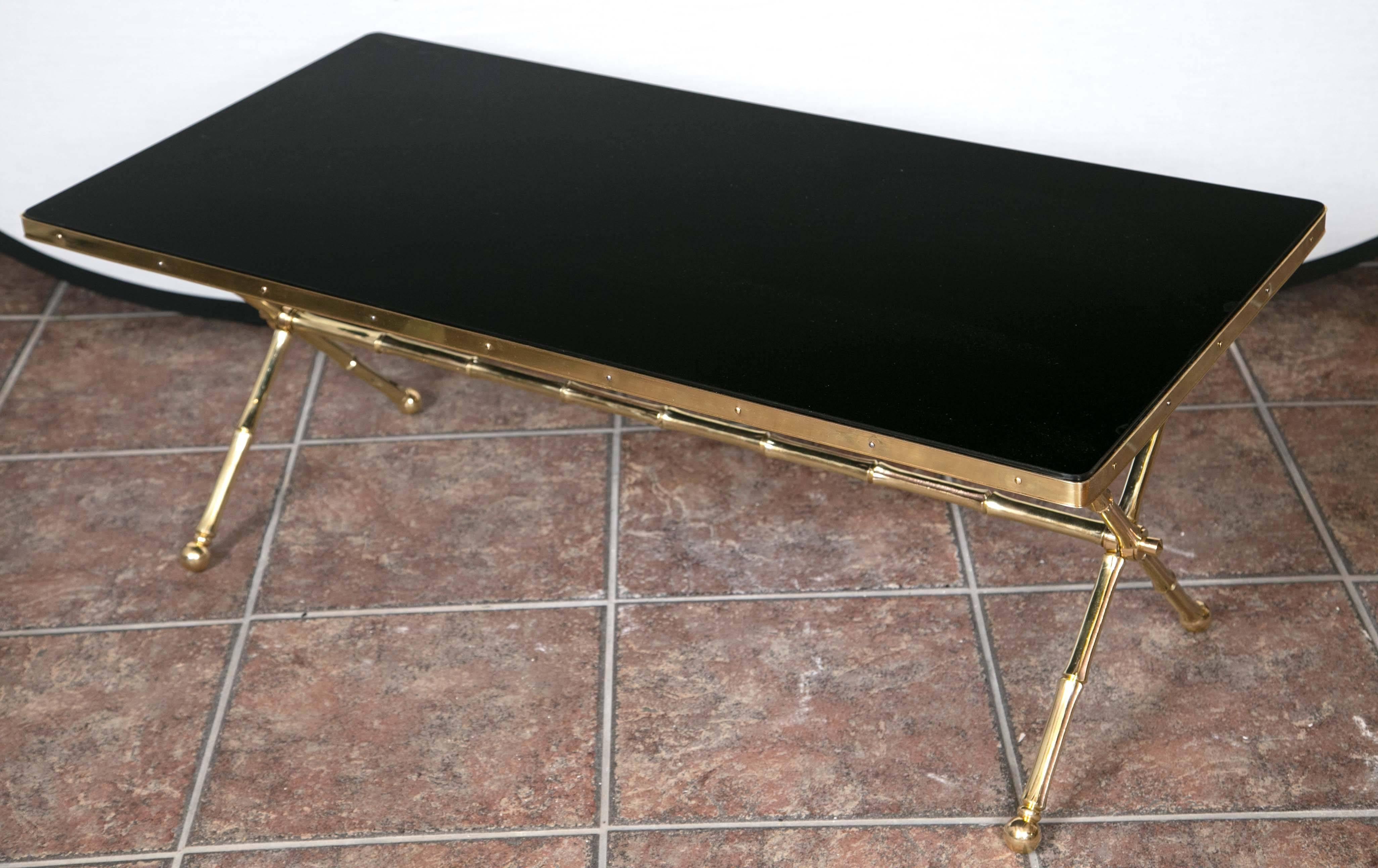 Jacques Adnet coffee table having inset black glass top supported on bronze faux bamboo X-form base.