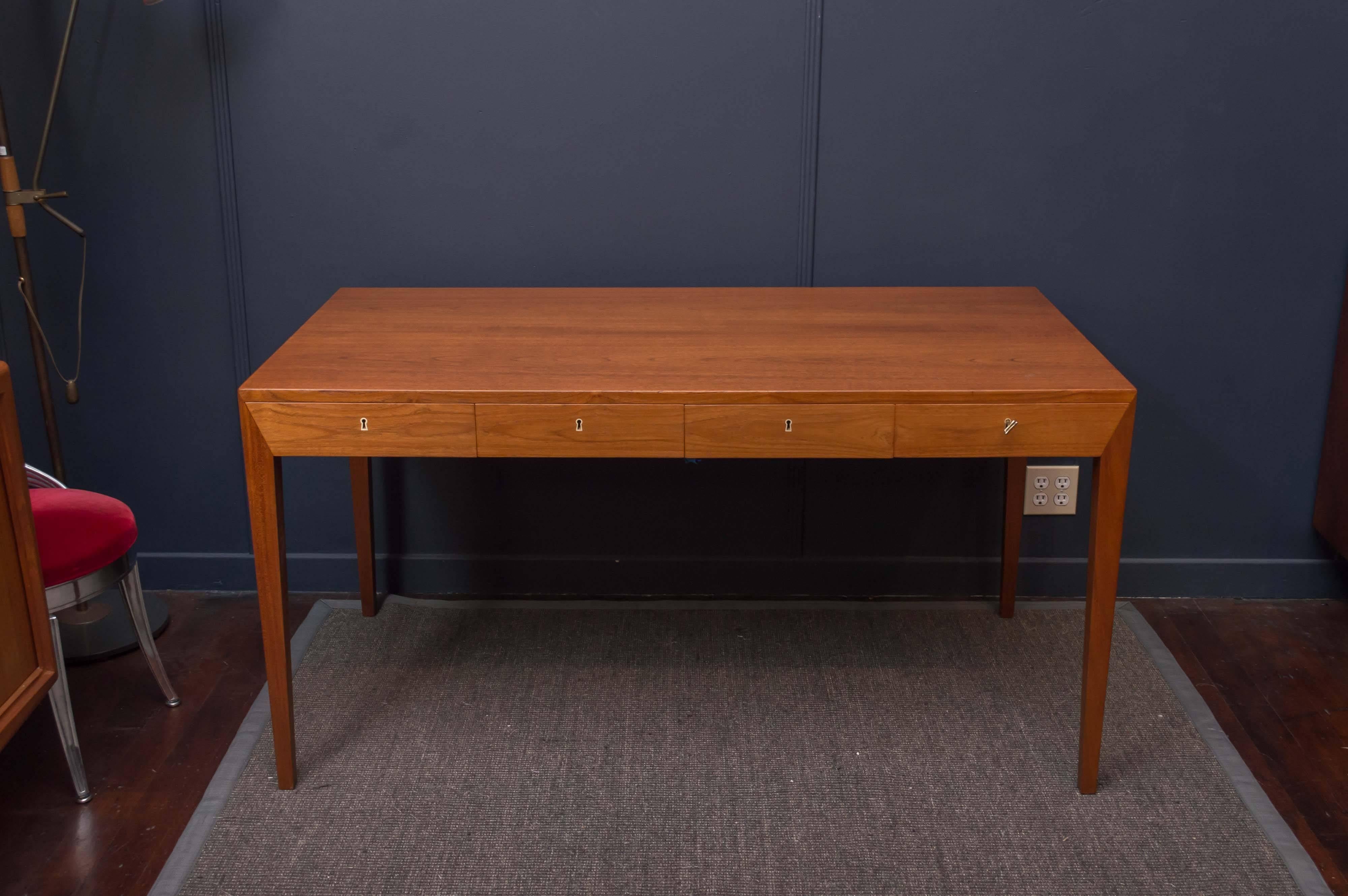 Elegant and simple design desk by Severin Hansen Jr. for Haslev Mobelsnedkeri, Denmark. 
Perfectly refinished with four drawers with brass escutcheon's on tapering legs. Stamped and Hallmarked.