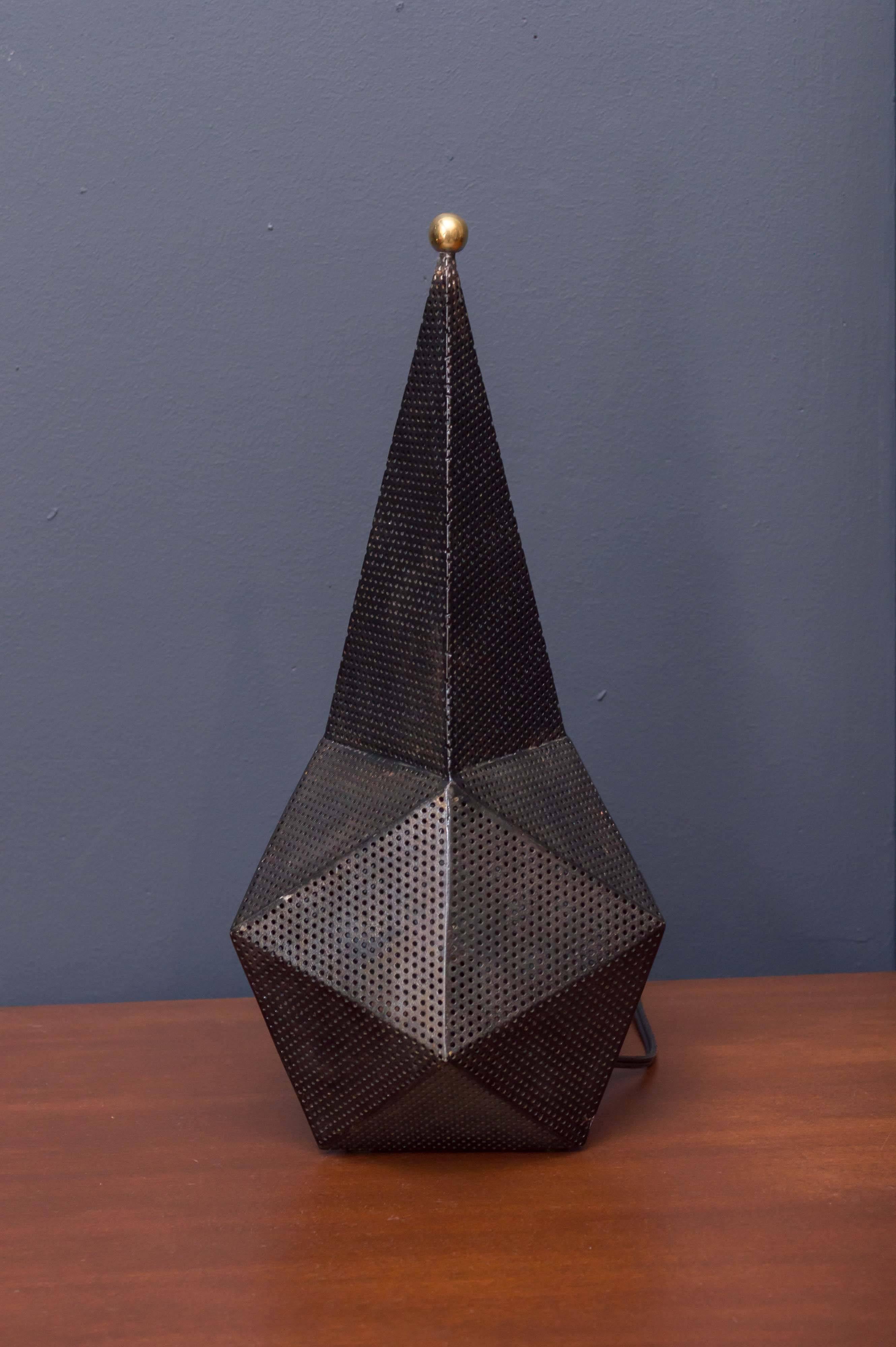Baghdad lamp influenced by Mathieu Matégot, France. Made from perforated and folded sheet metal with a brass finial handle. 
Newly re-wired in very good original condition.