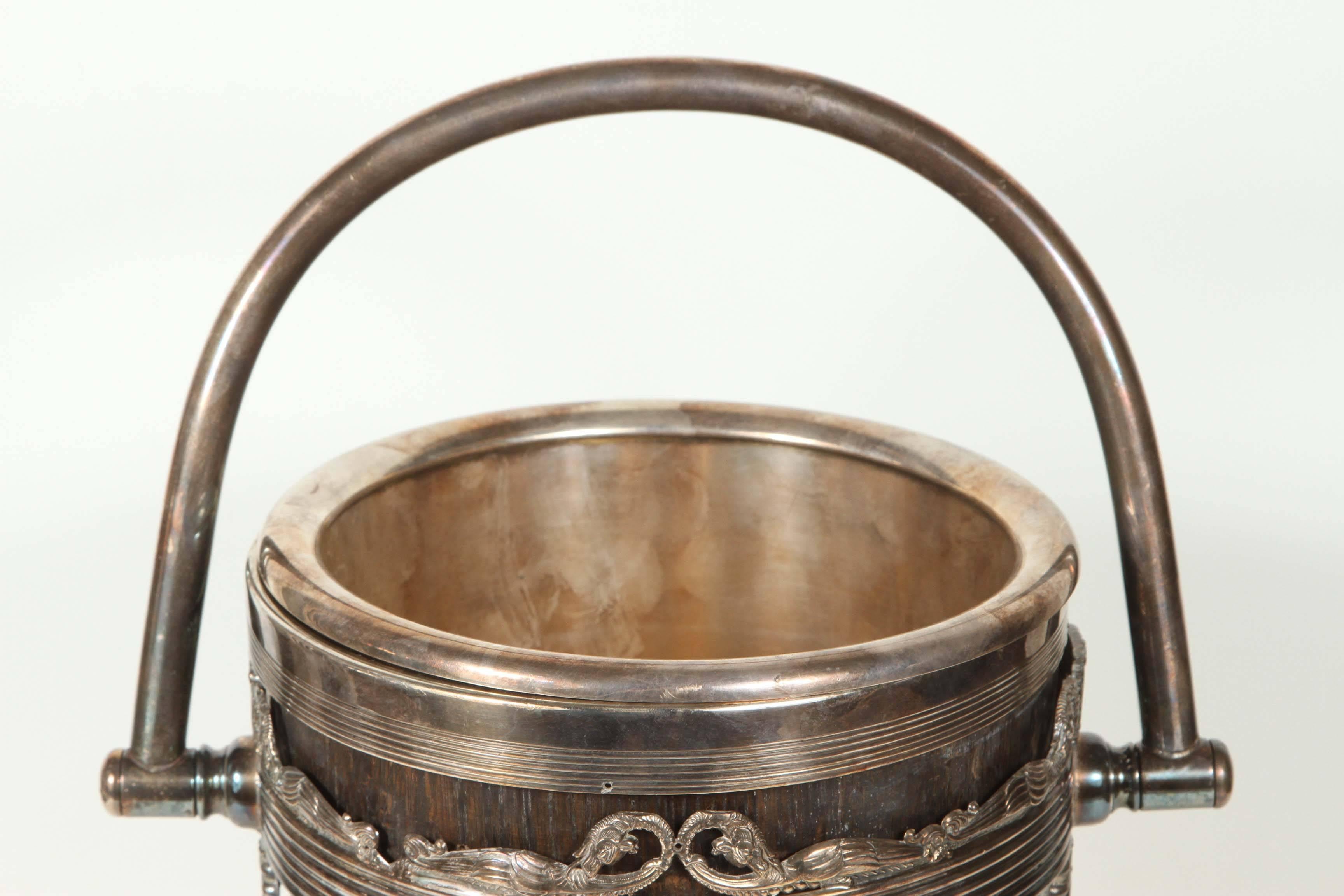 Ice bucket with sterling silver detailing. Elaborately decorated in a dragon motif.
