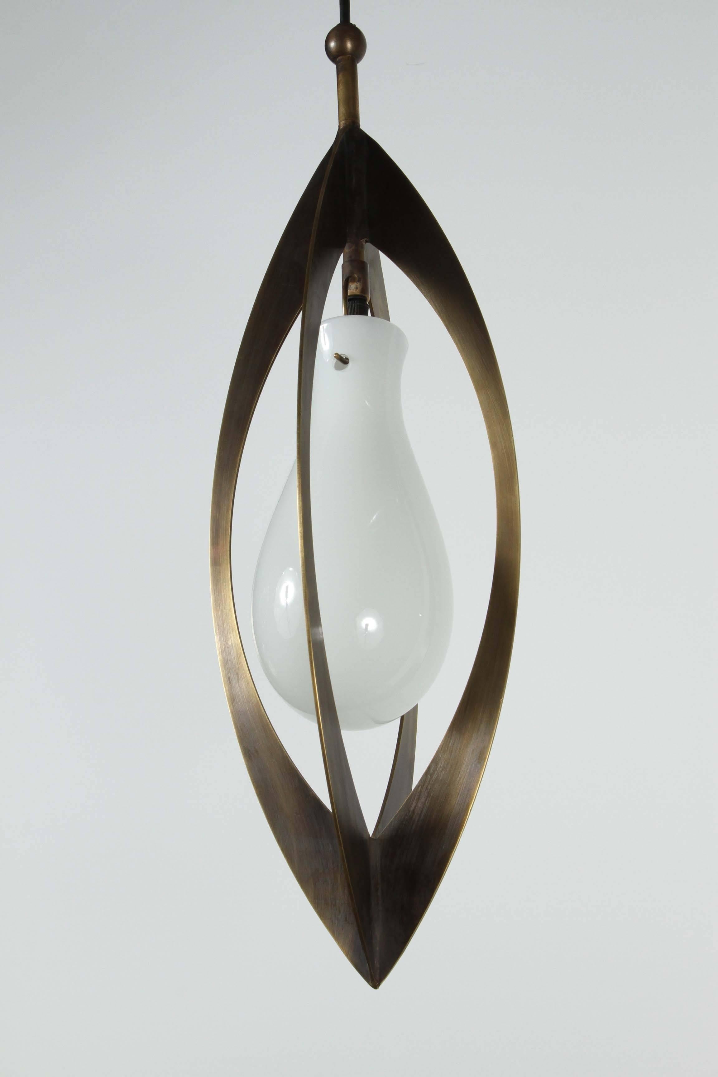 Modern antiqued brass pendant with white glass shade.