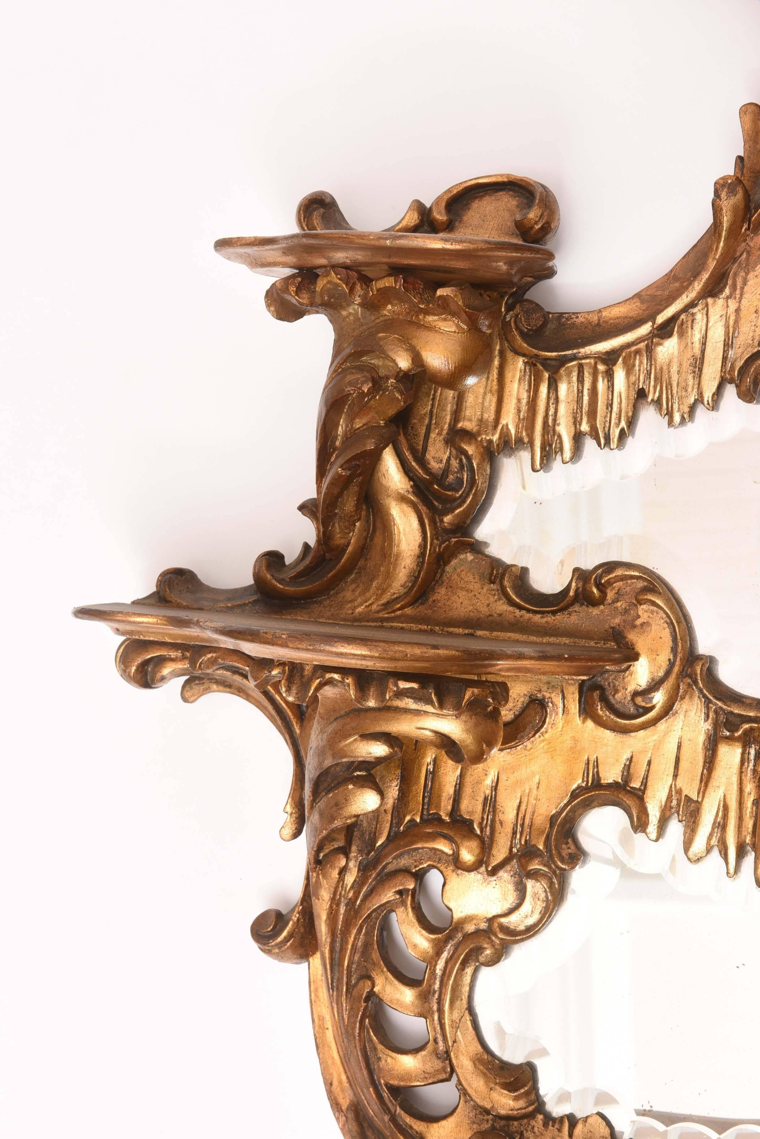 Beautifully carved and gilded Chinoiserie six shelf mirrored wall bracket.