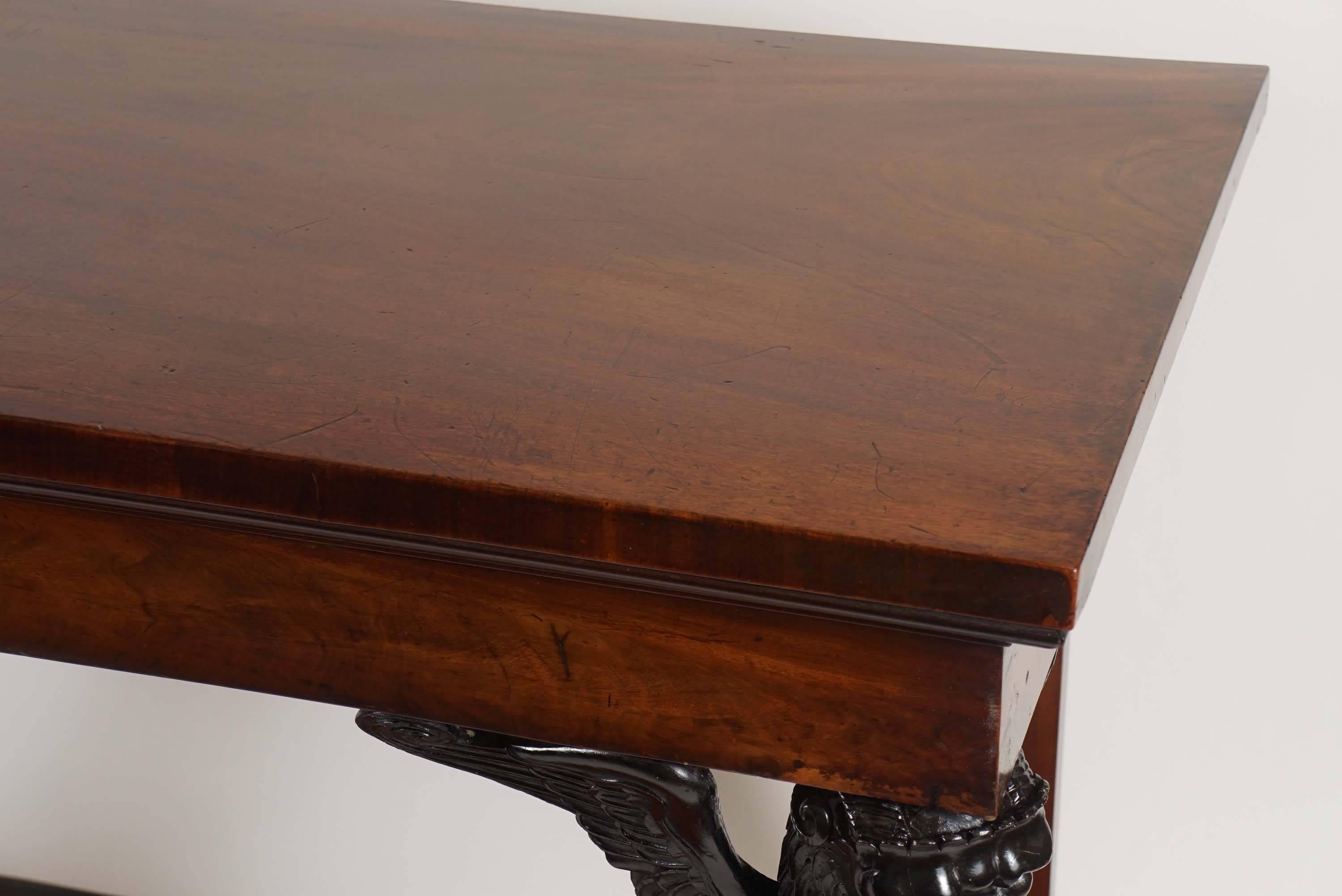 An important and exceptional neoclassical English Regency period mahogany side table, serving table, or sideboard of monumental size in the manner of Thomas Hope of rectangular form having blunt-edge top above 'echinus' and stepped fillet molding