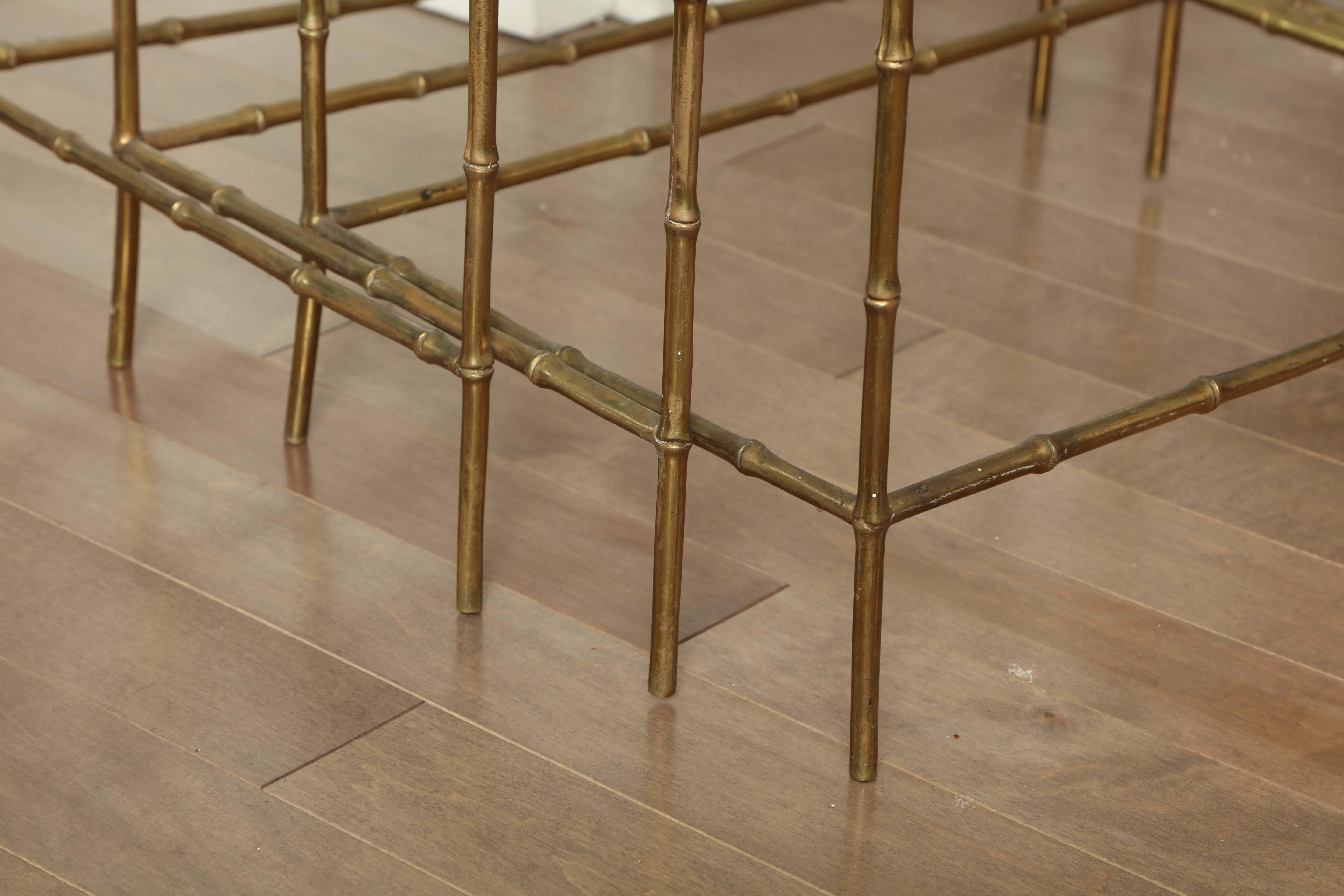 Set of three brass bamboo style nesting tables in the manner of Baques, French, circa 1950.