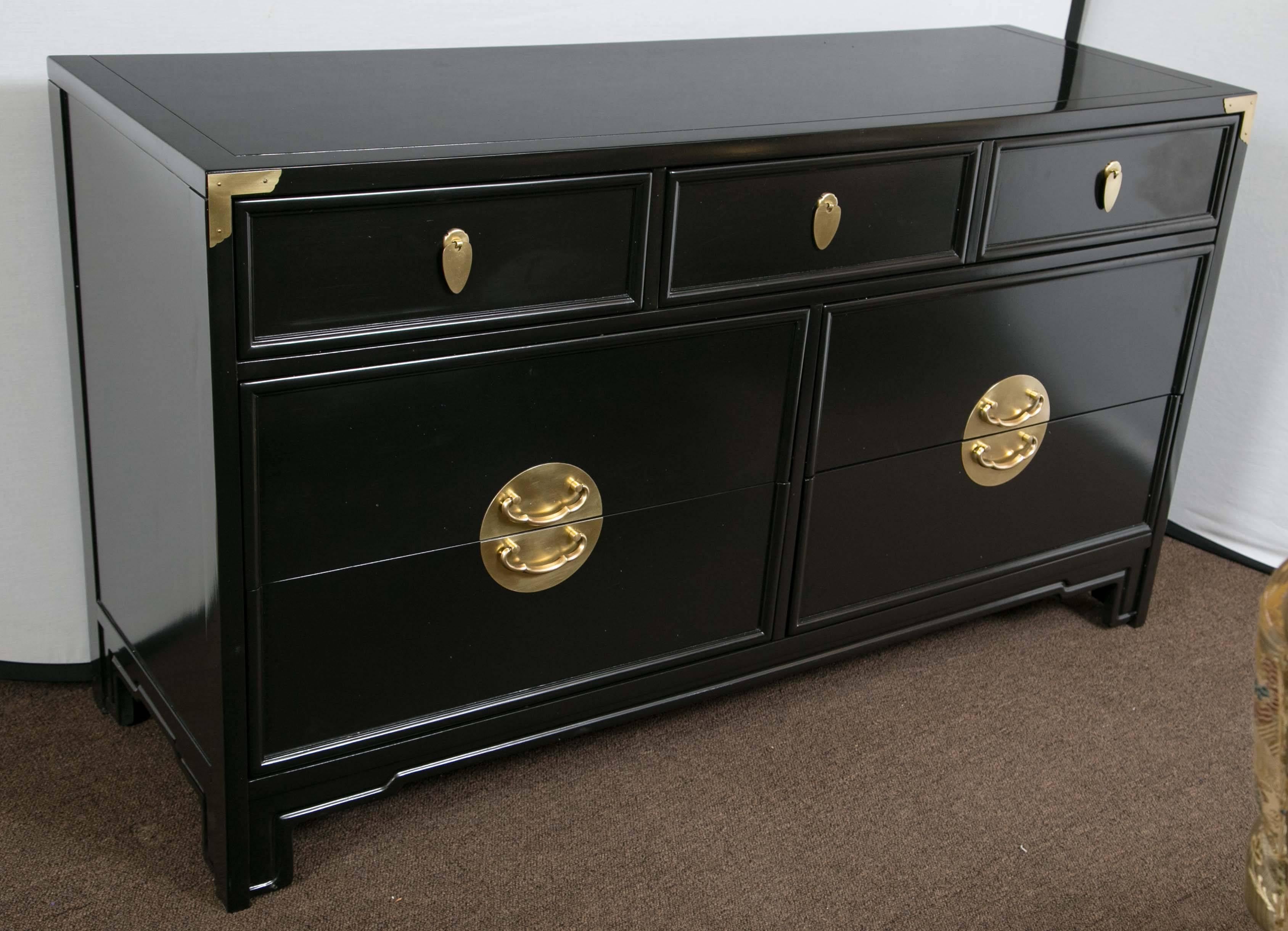 A pair of Kent Coffey Asian style black lacquer cabinets two over four drawers with brass hardware each signed as photographed. Each case in a fine Steinway Piano hi gloss finish. The pair of commodes have polished brass handles and hardware to add