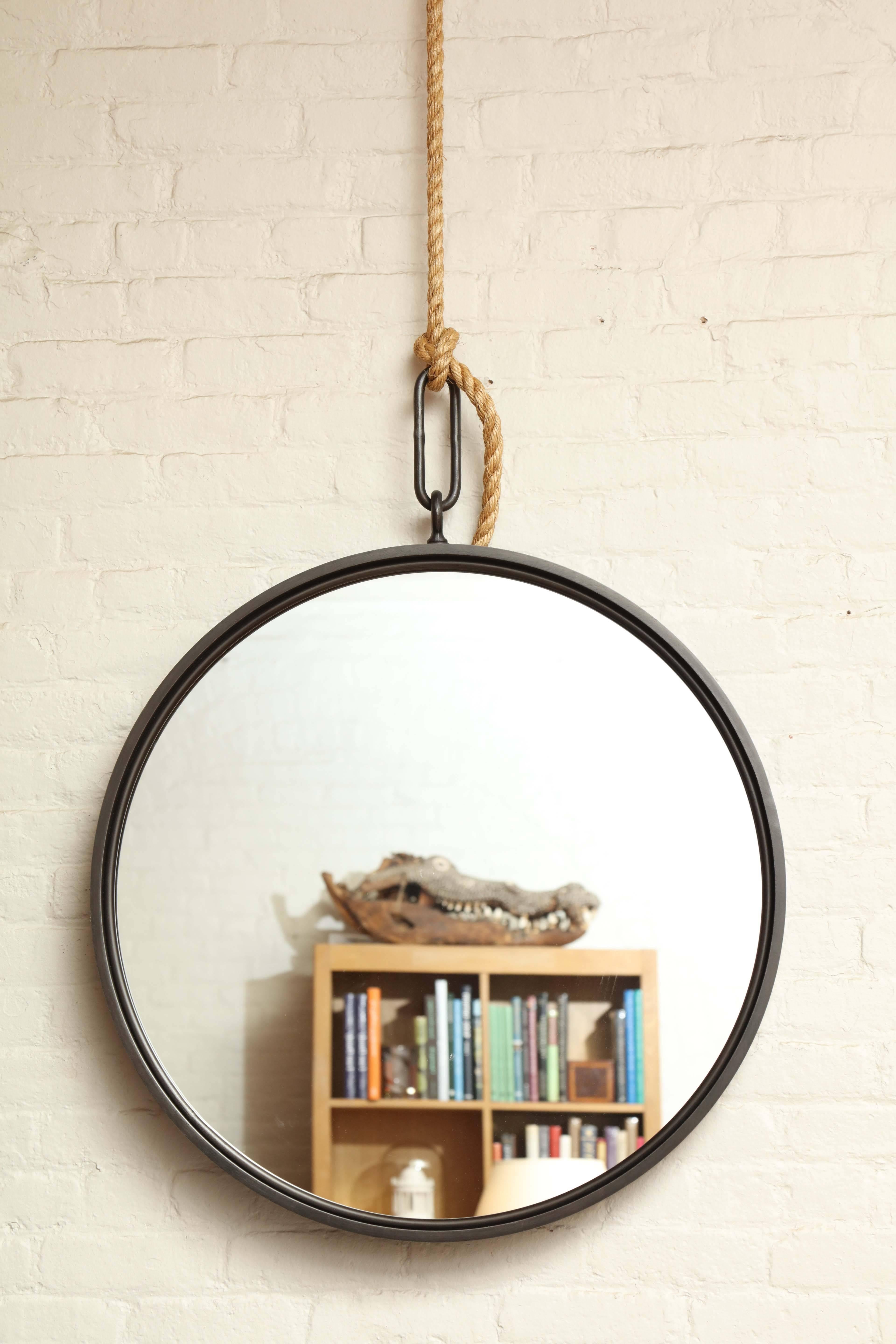 A BURDEN Contemporary round pendant mirror in blackened steel with clear glass. Can be hung directly on backplate (provided) or on rope (please specify rope length). Two available in 30.5