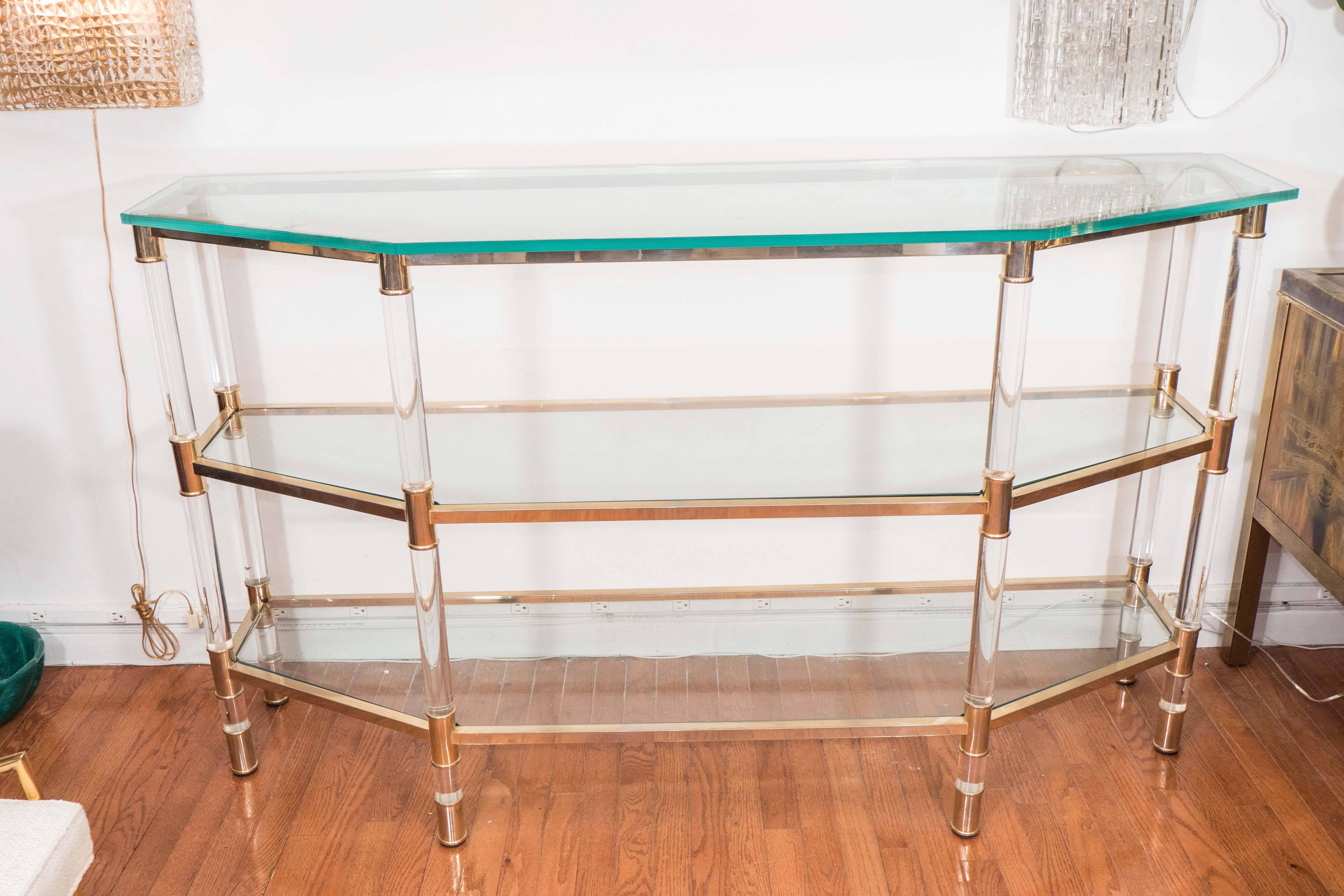 Three-tier Lucite and brass console table featuring glass tops.