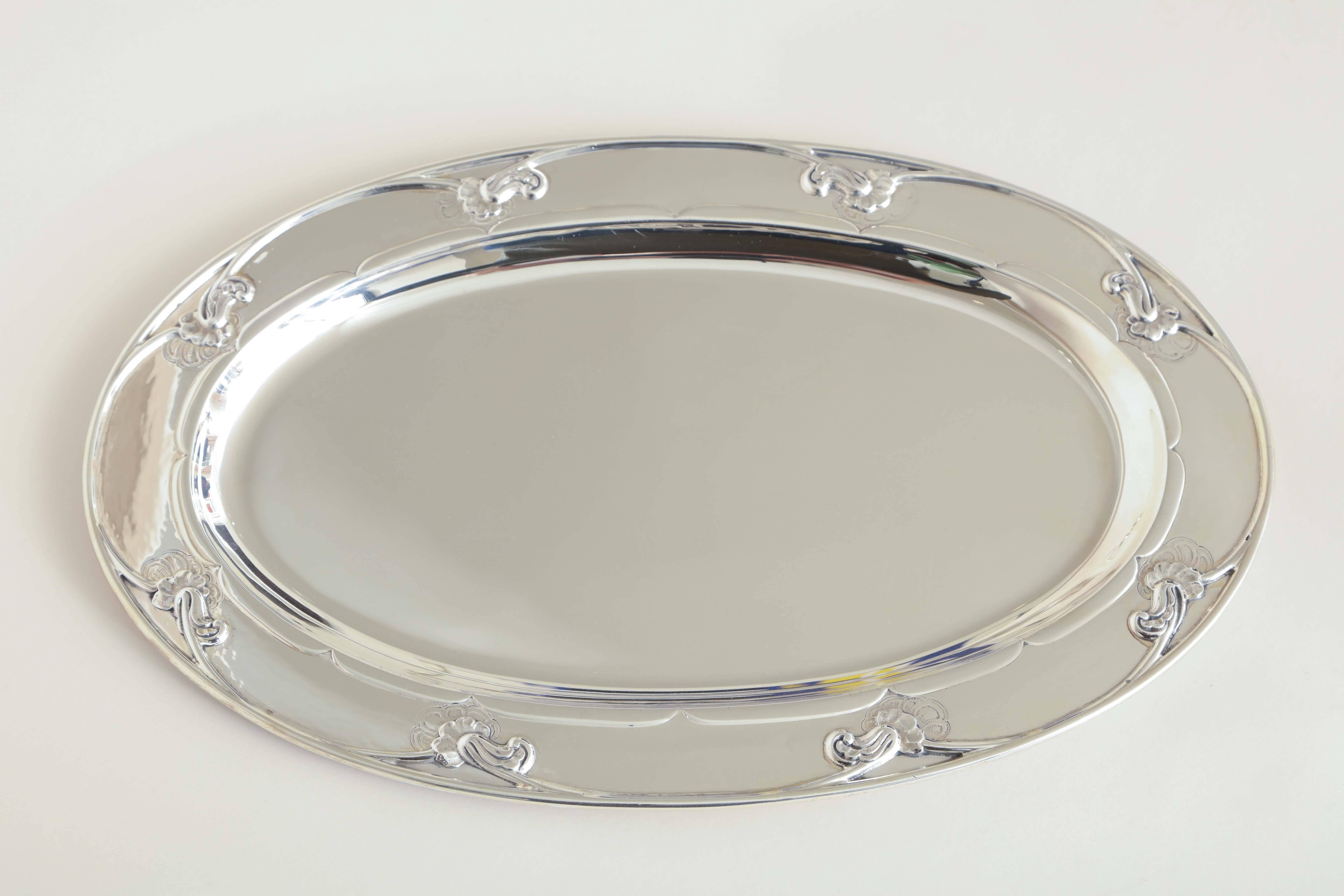 Oval tray with stylized blossom border.
Impressed with Georg Jensen mark for 1945-present/ STERLING/ DENMARK/ 230 D.
29.60 ozs.

(Price shown is reduced price, no further trade discount) 