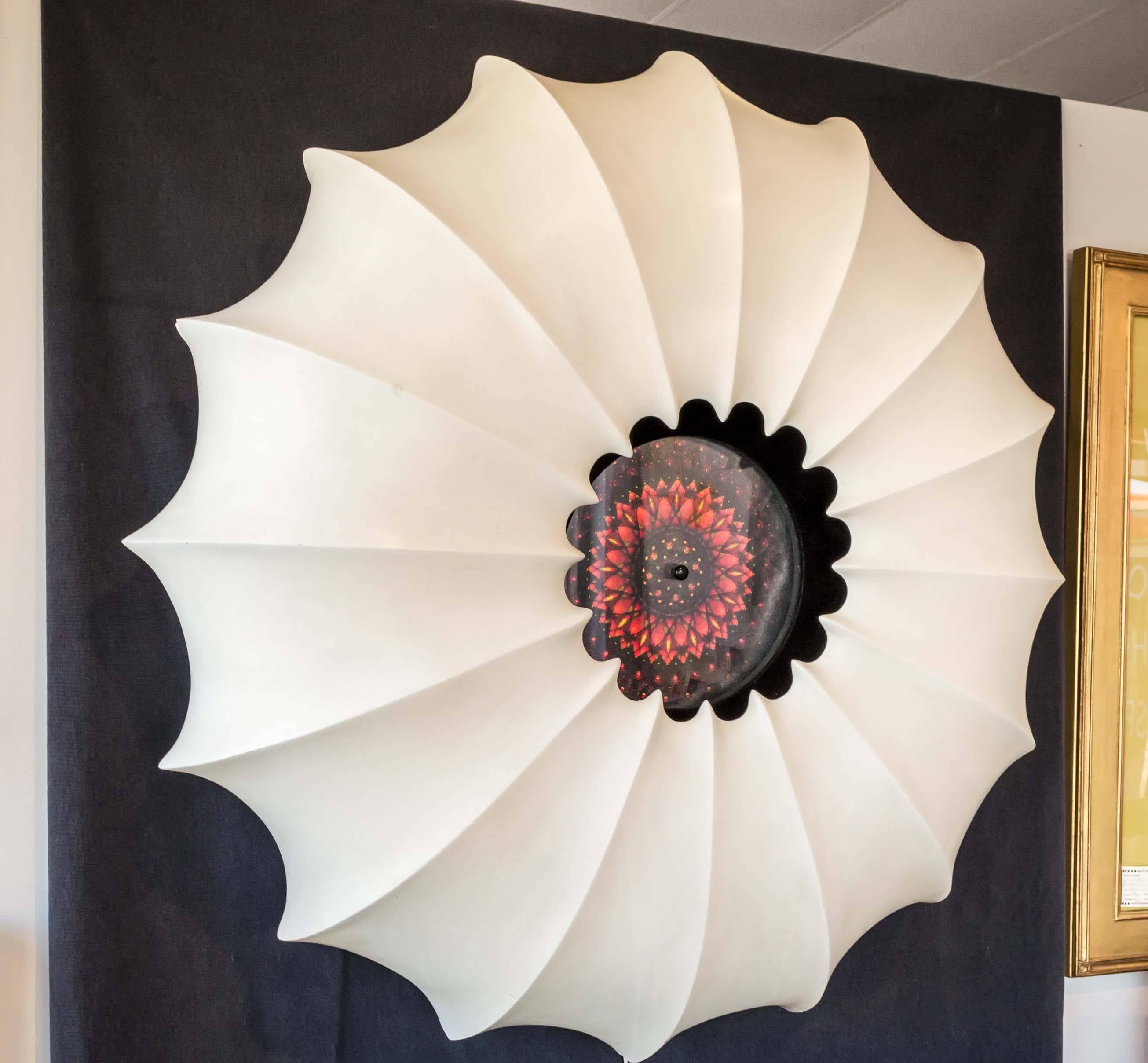 A monumental plaster composite wall sculpture with lighted and rotating kaleidoscope or mandala center.

This fantastic piece of Mid-Century Modern art is both a conversation starter and a show stopper. Besides making a room, it provides an