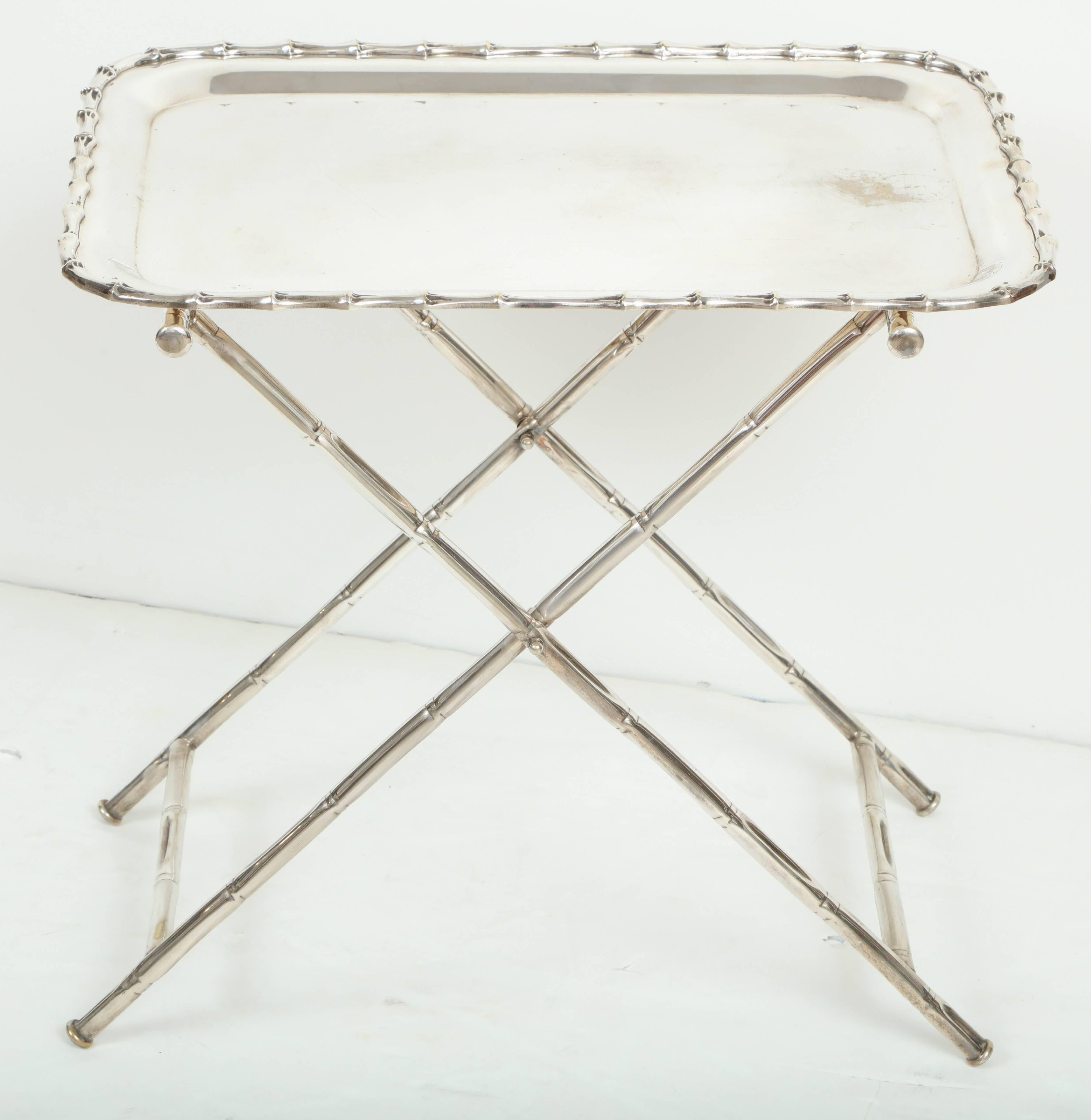This chic tray table is not just for desserts! Silver plate with a faux bamboo motif, this versatile piece can serve as a side table, a small bar or drinks tray or a perfect spot for books or magazines. Tray is removable from folding base for easy