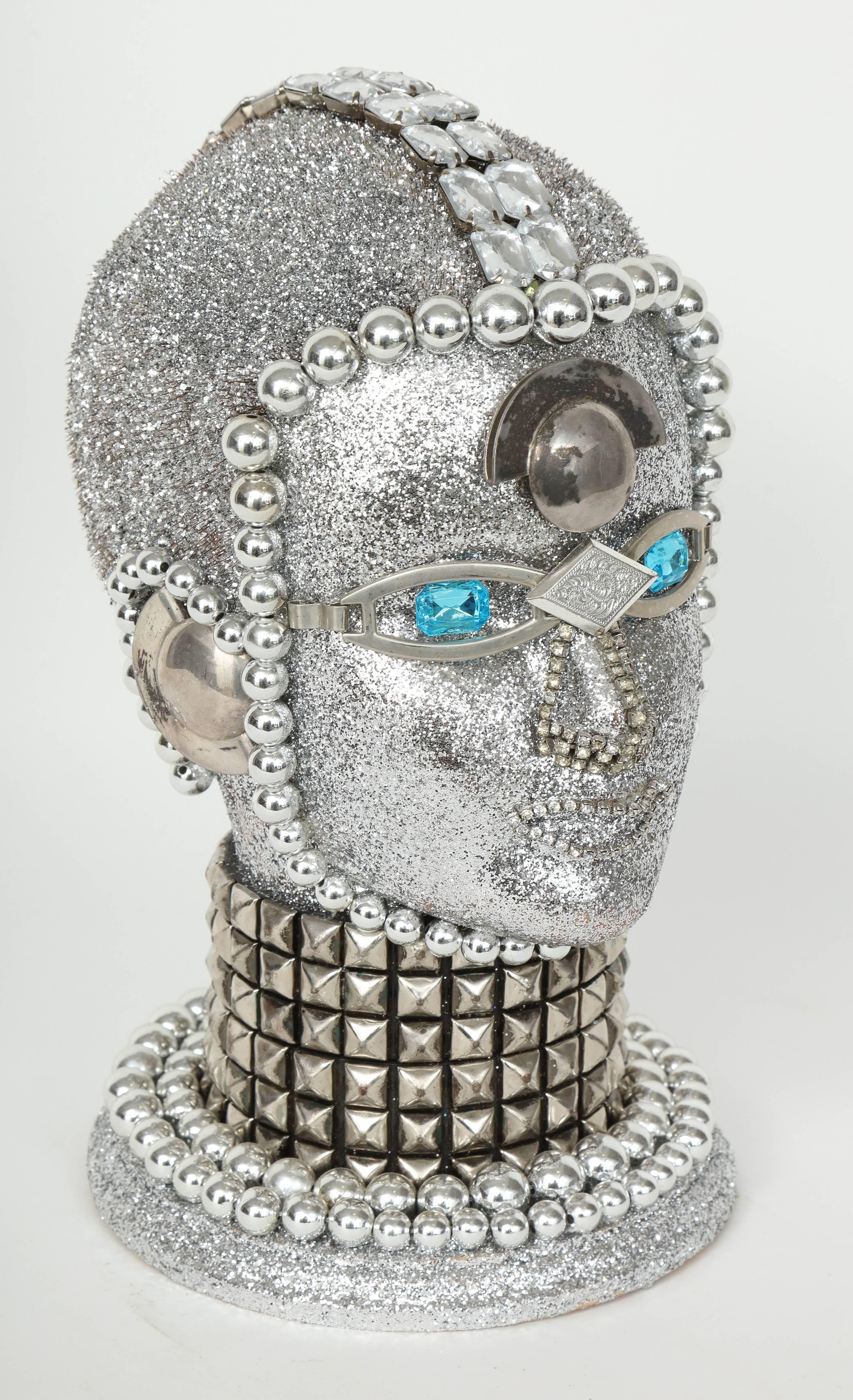 Futuristic silver metallic android bust by W. Beaupre composed of vintage jewelry findings.