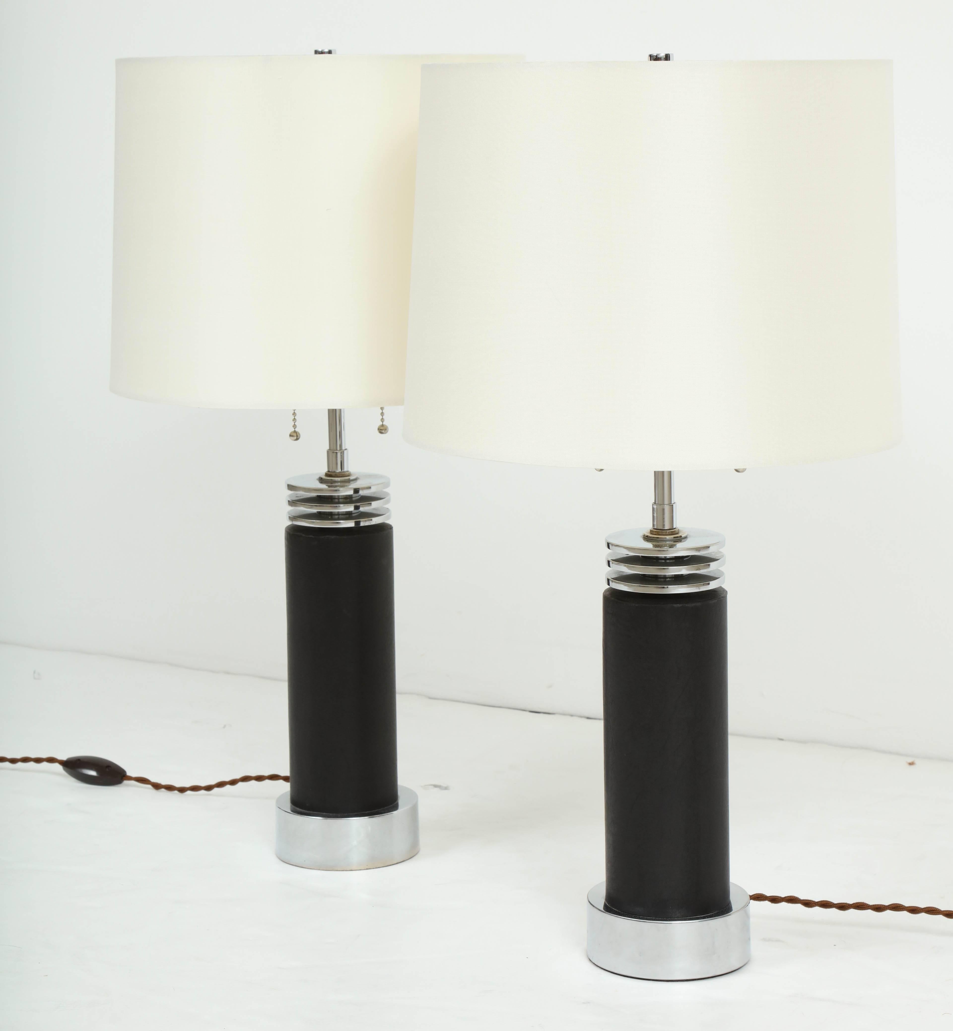Pair of chrome Art Deco bedside table lamps clad in black goatskin, circa 1940.