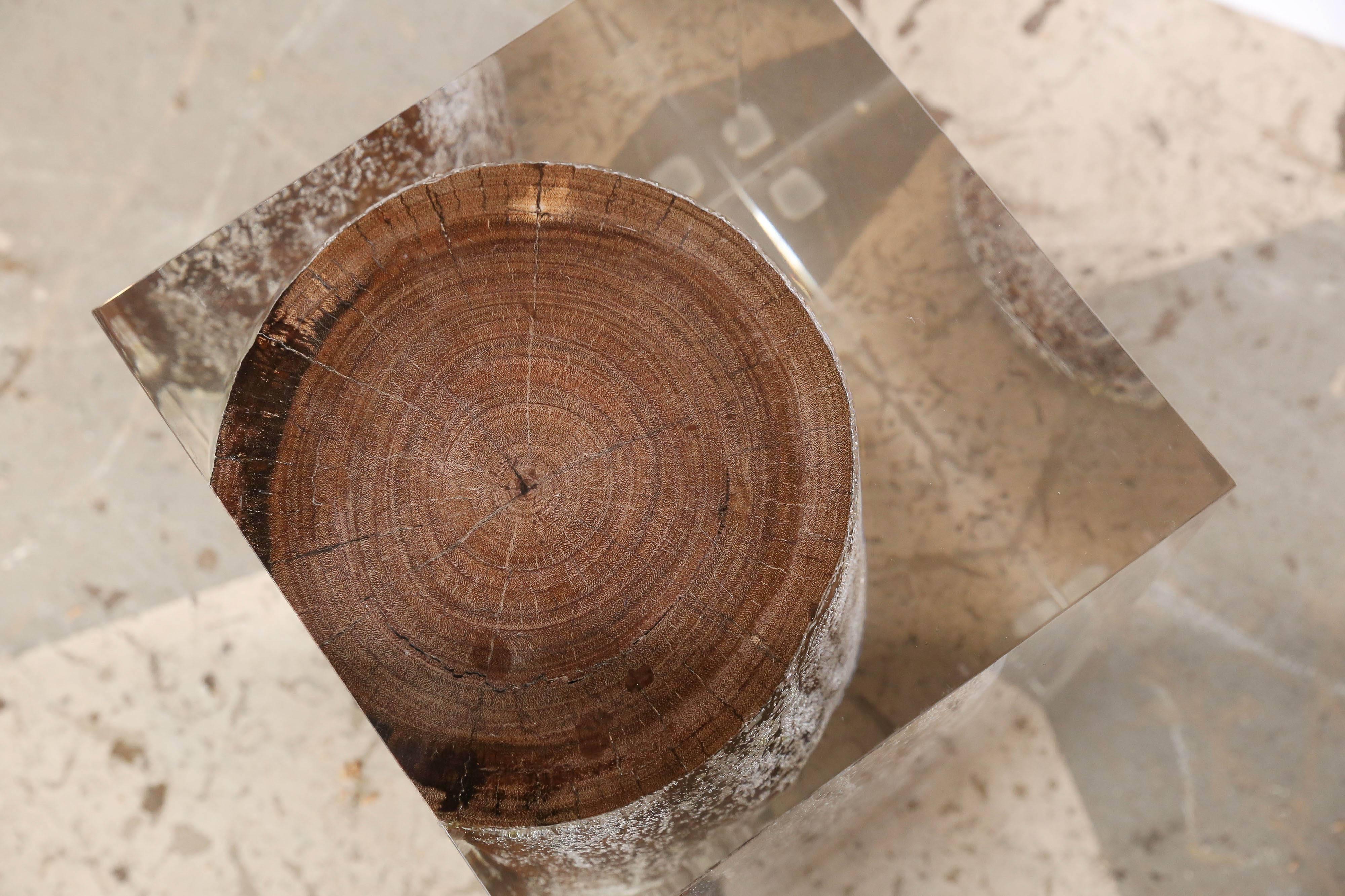 Handcrafted acrylic glass embedded with driftwood trunk that is sized either as a side table or seating as a stool or ottoman. Cut, sanded and hand polished to a perfect transparency. Consider it a work of art that you can also sit on.

This