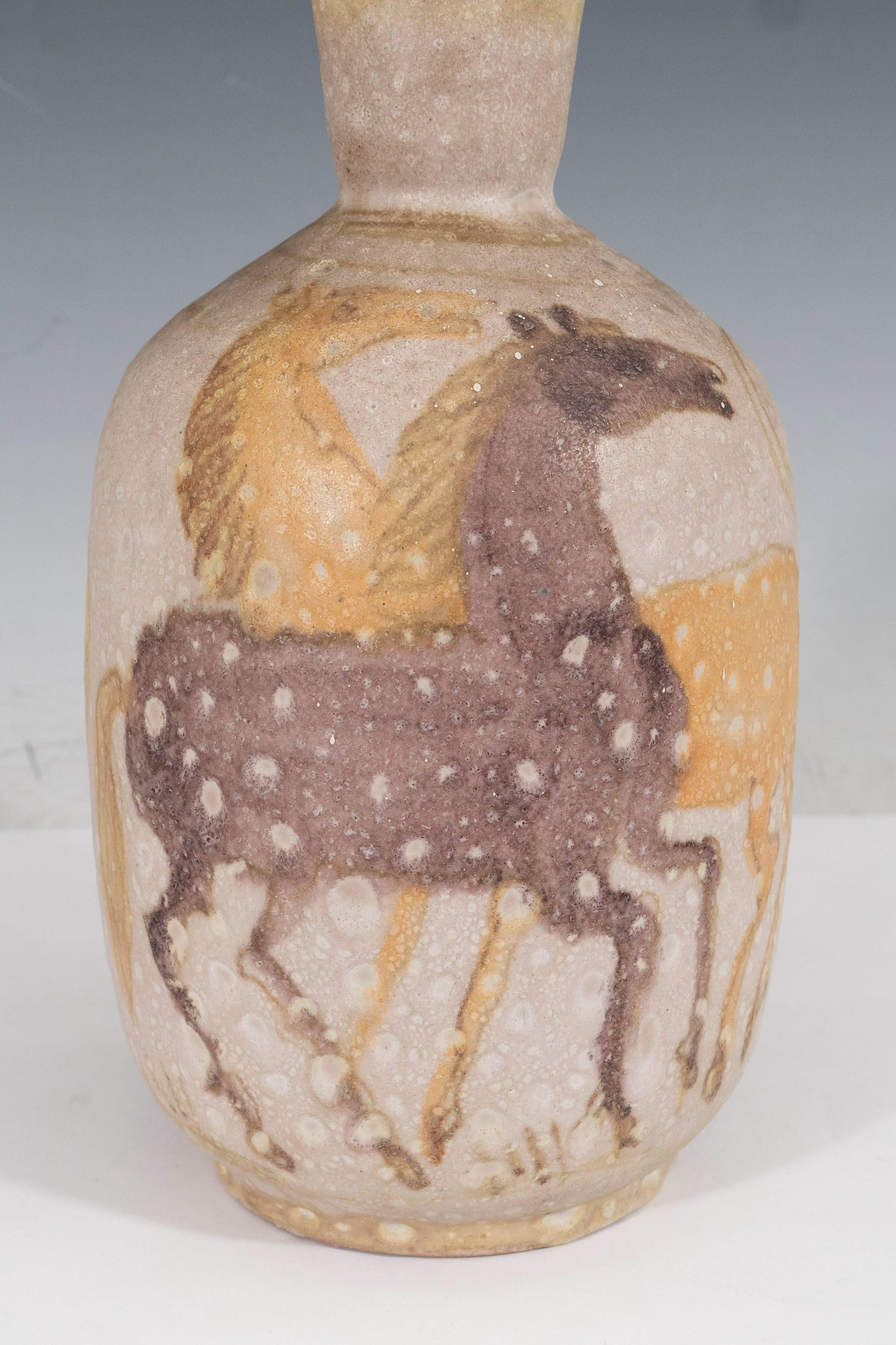 A mottled ceramic vase by artist Guido Gambone, produced in Italy, circa 1950s, painted with horses in the primitivist style. Markings include signature to underside of the vase. This piece is in very good vintage condition, wear consistent with age