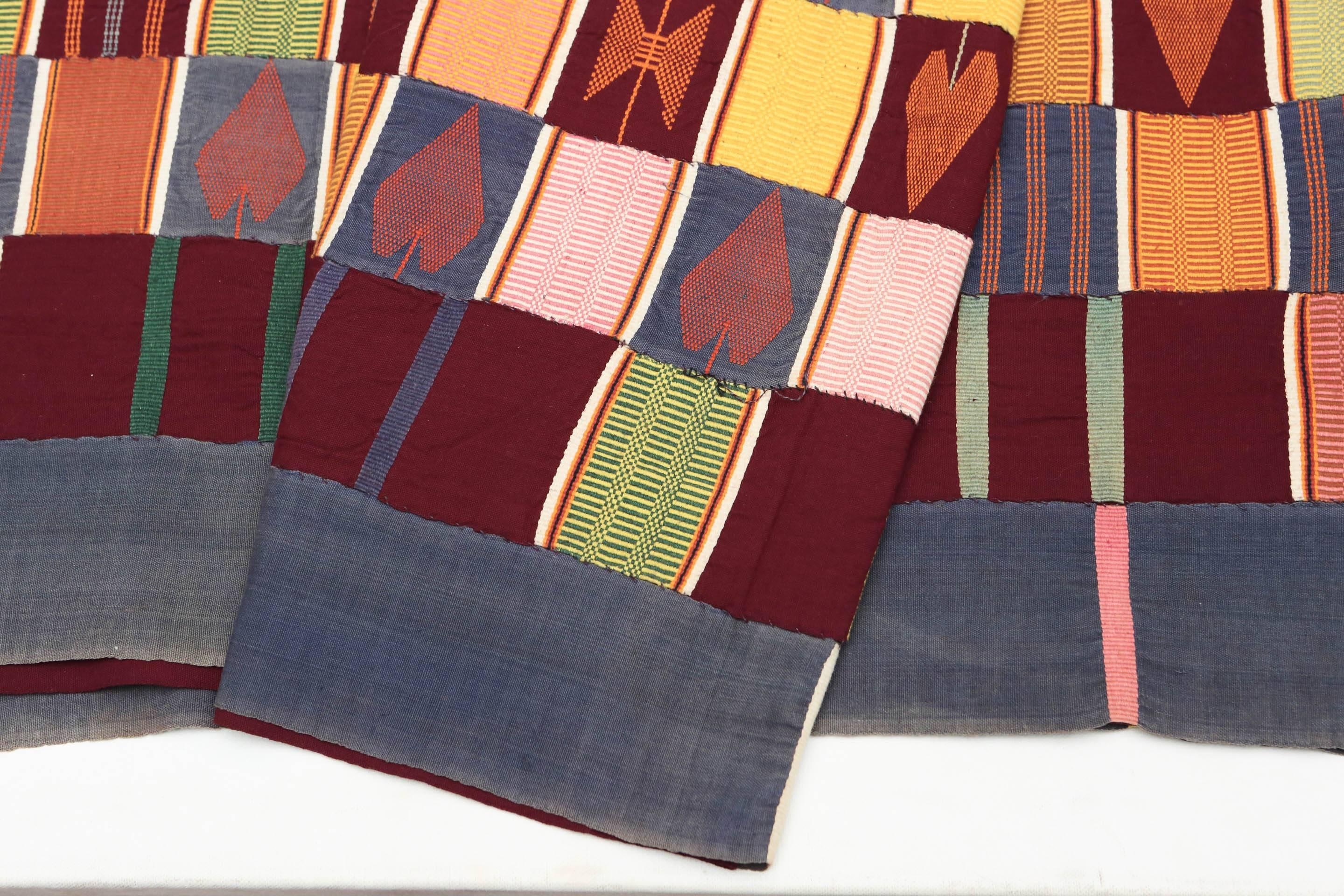 Late 20th century strip woven ewe tribal kente cloth, Ghana. Handwoven, brocaded panels sewn together. Measures: 60 x 112.
