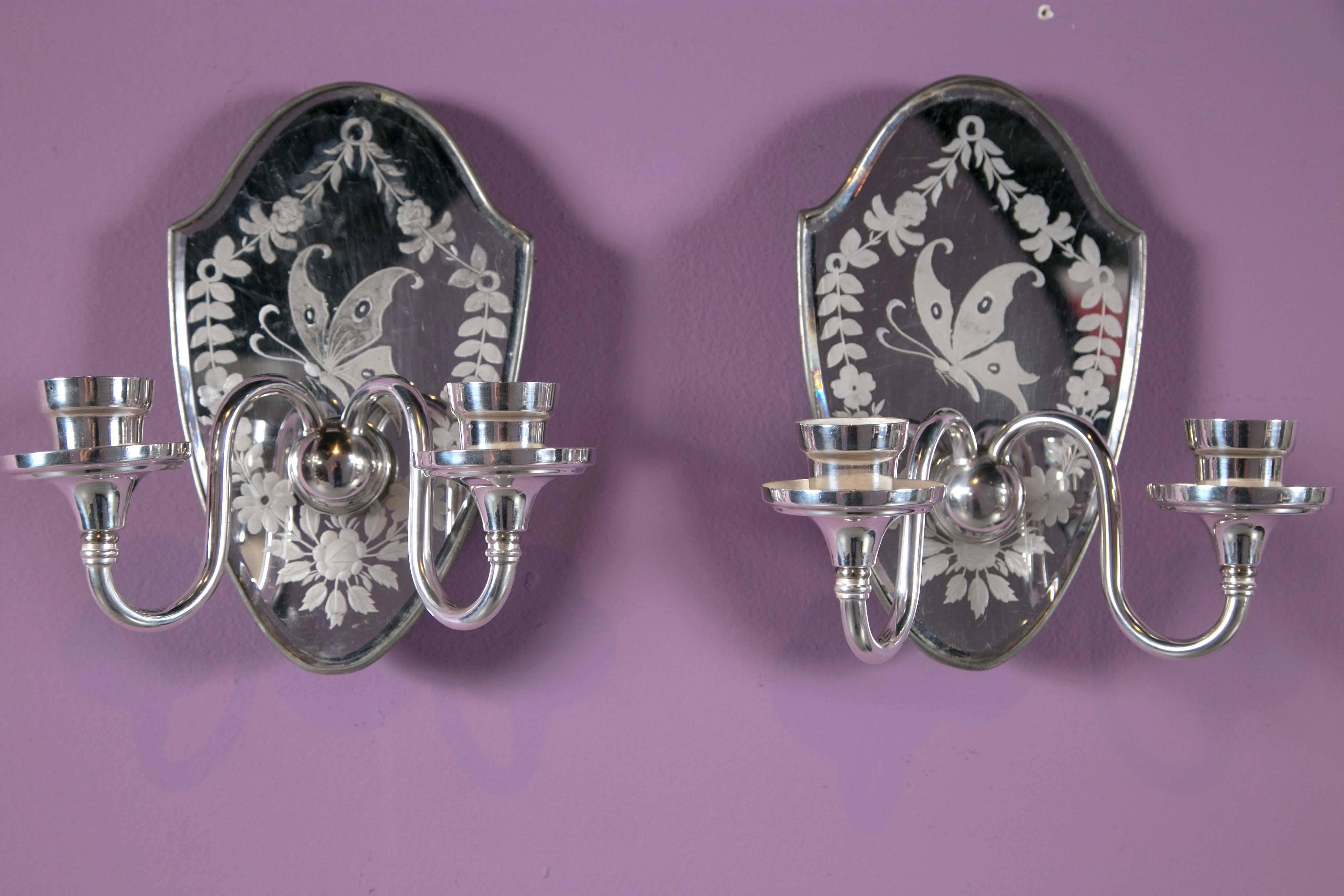 A lovely pair of silver plate and etched mirror Caldwell sconces garlands and butterflies make this a whimsical addition to your home.
