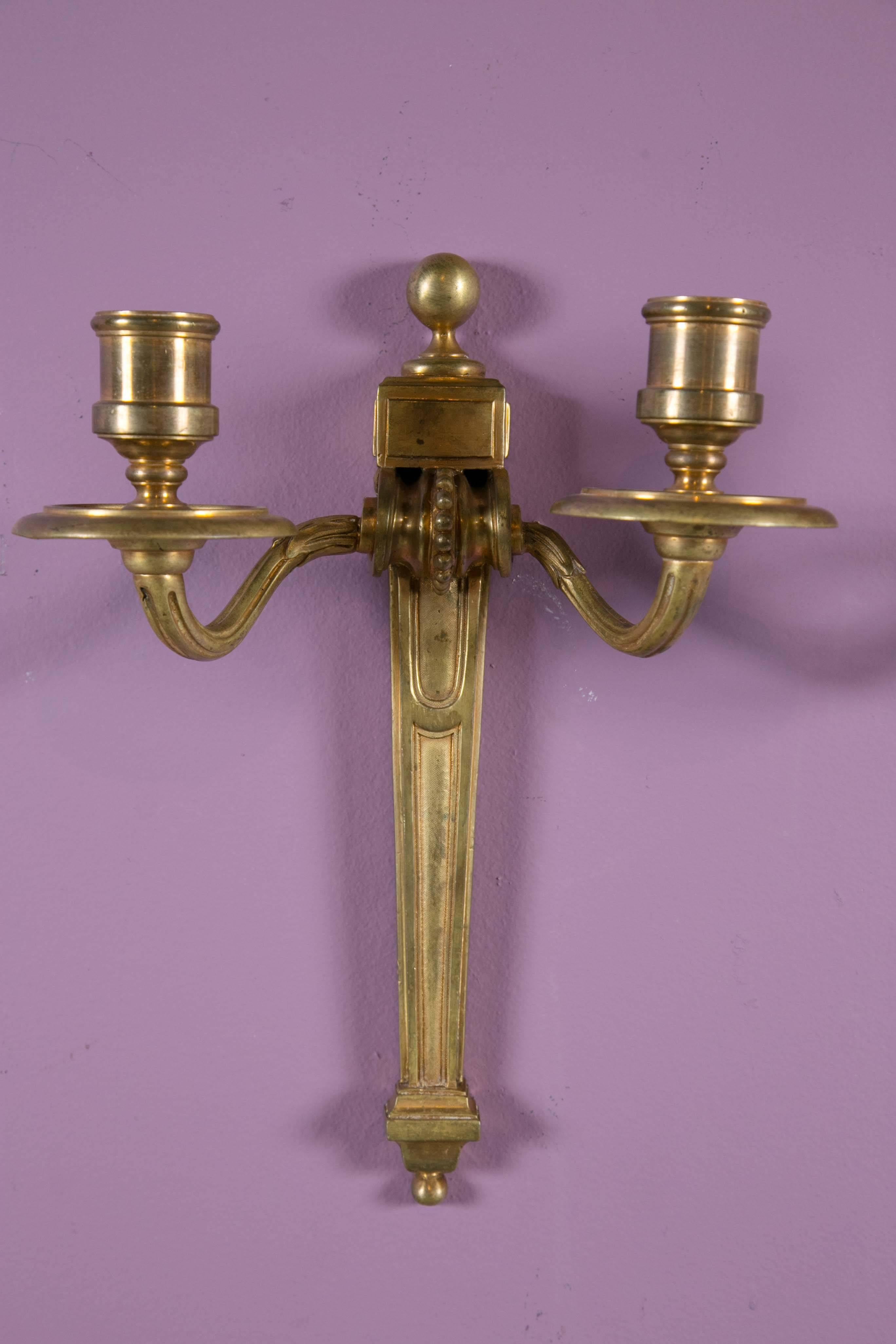 Beautiful neoclassical gilt bronze Caldwell sconces. Two pairs available, priced per pair.
