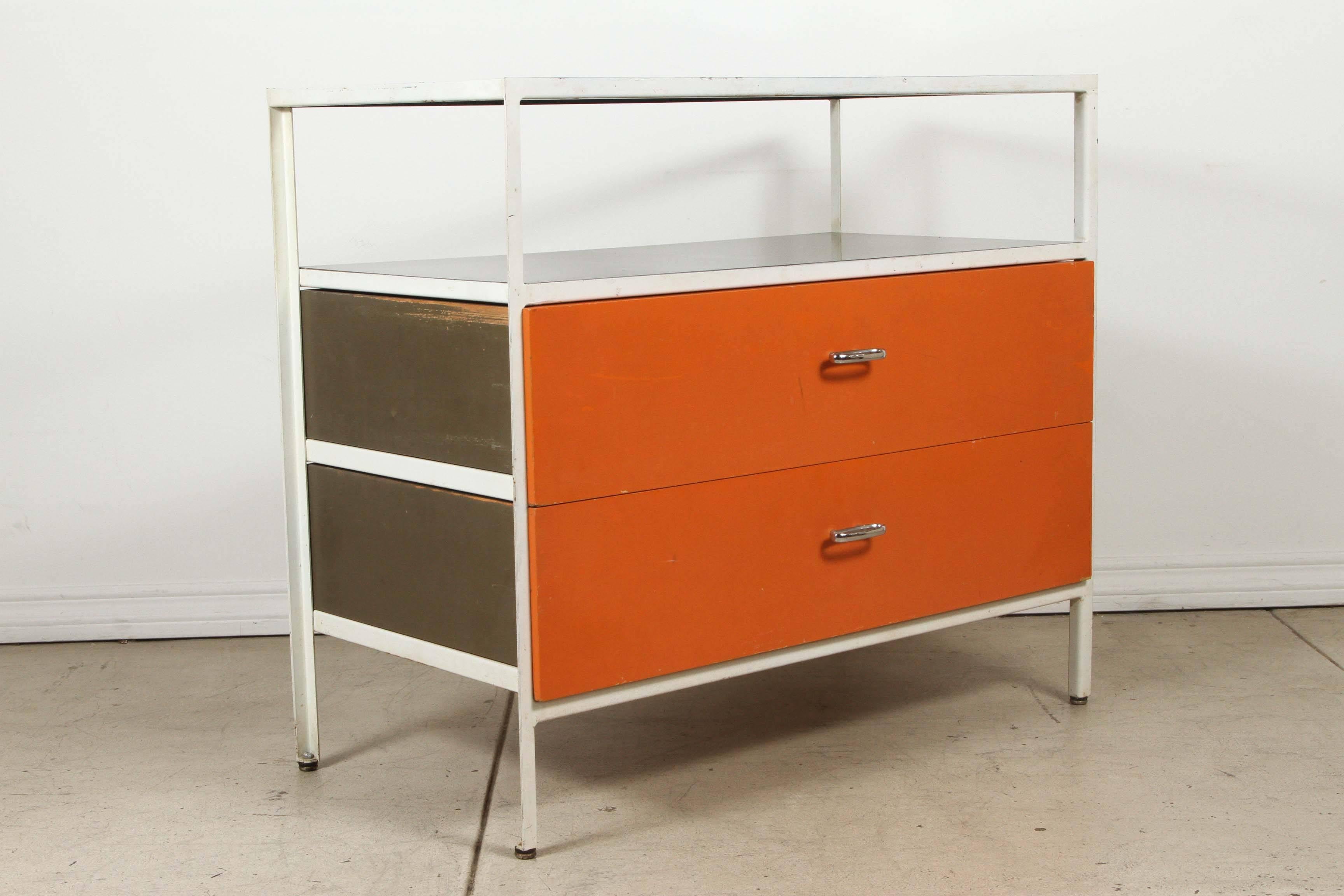 Classic Nelson series 4000 steel frame case for Herman Miller. Original label partially intact. Two drawers with original chrome pulls in iconic HM orange with glass top/shelf.
