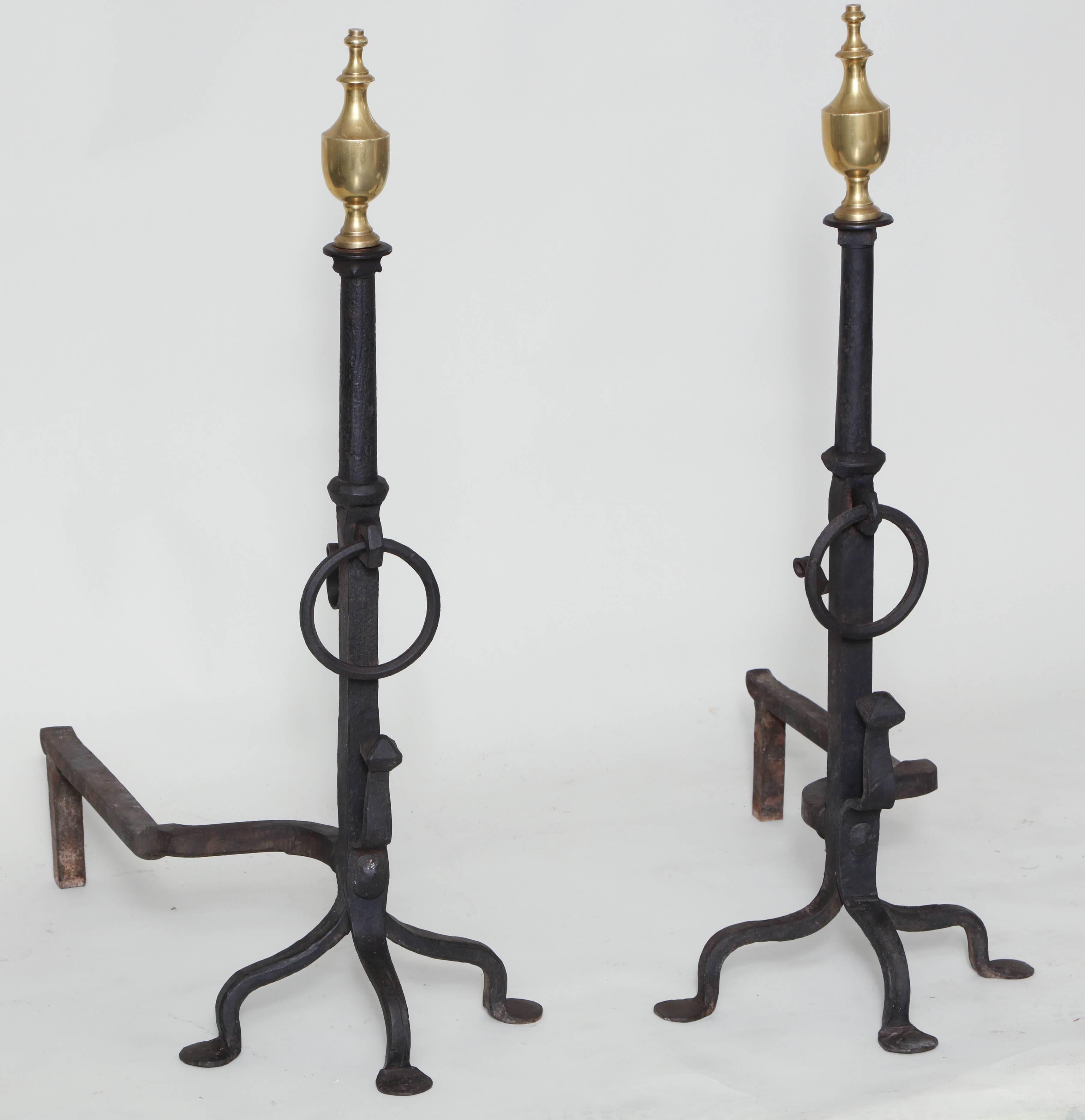 Good pair of brass and wrought iron Federal style andirons of impressive scale, the brass urn finials over column shaped upper shafts, ringed centers, standing on three shaped legs ending in penny feet.