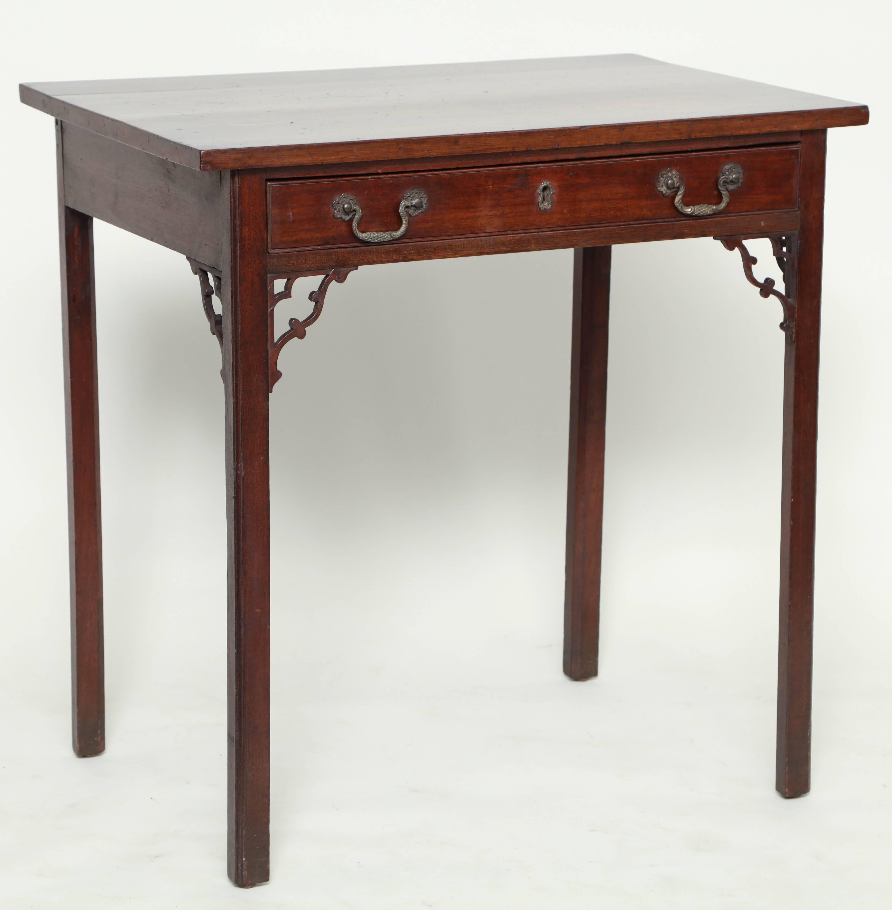 Good George III mahogany side table, the square edged top over single drawer having original highly detailed brasses and escutcheon, over four square legs adorned with open fretted corner brackets, the whole with rich, pleasing color.