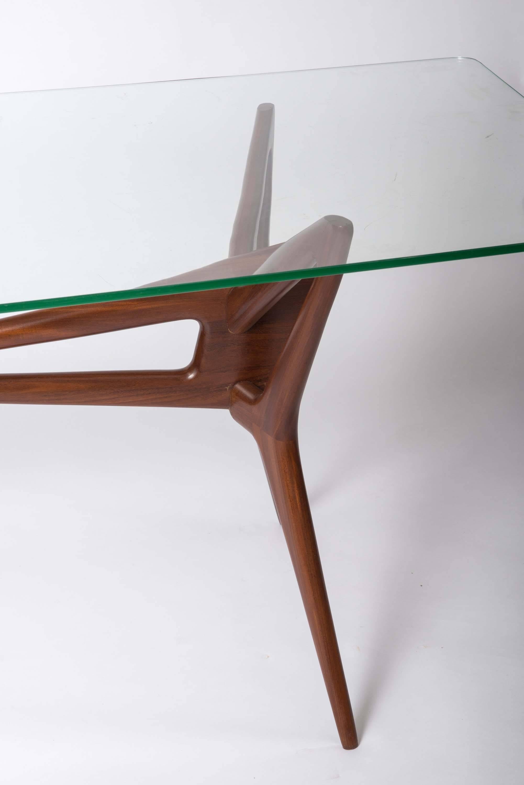 An Italian beech centre table attributed to Franco Campo & Carlo Graffi.
The splayed spider legs supporting a rectangular shaped glass top,
Italy, circa 1950.
Measures: 78 cm H x 170 cm W x 81 cm D.