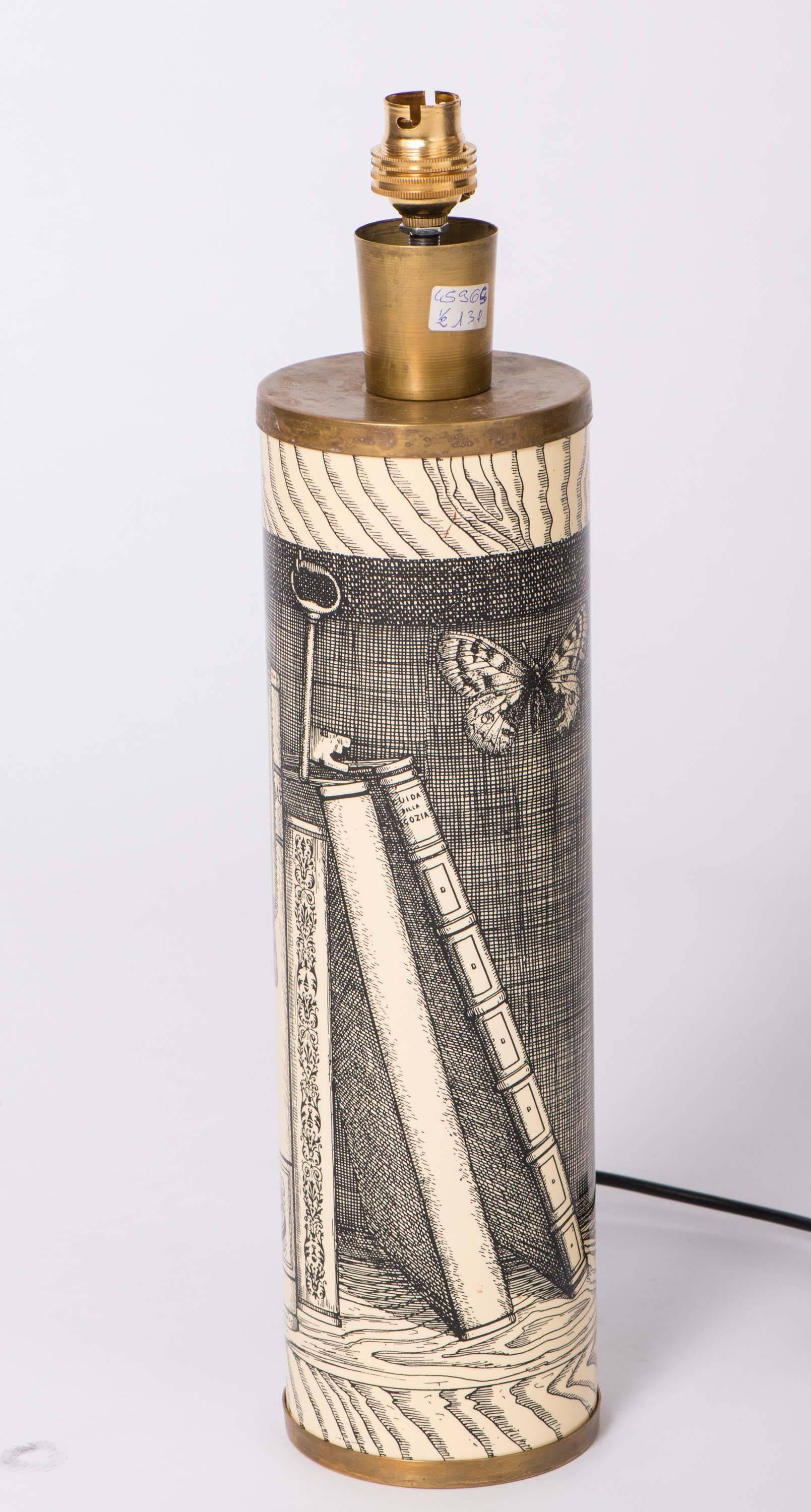 An early lamp by Piero Fornasetti.
“Libri.”
Metal work, lithographically printed.
Brass.
Italy,
circa 1960.
10 cm diameter.
        