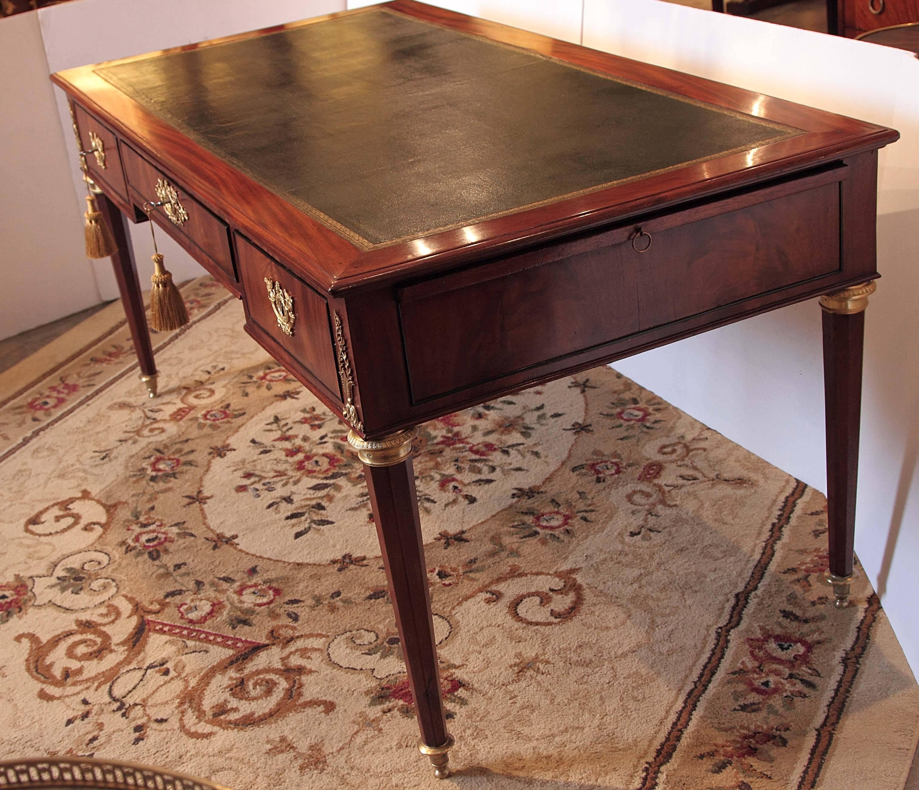 Late 18th century French Louis XVI leather top mahogany and gilt bronze bureau plat.