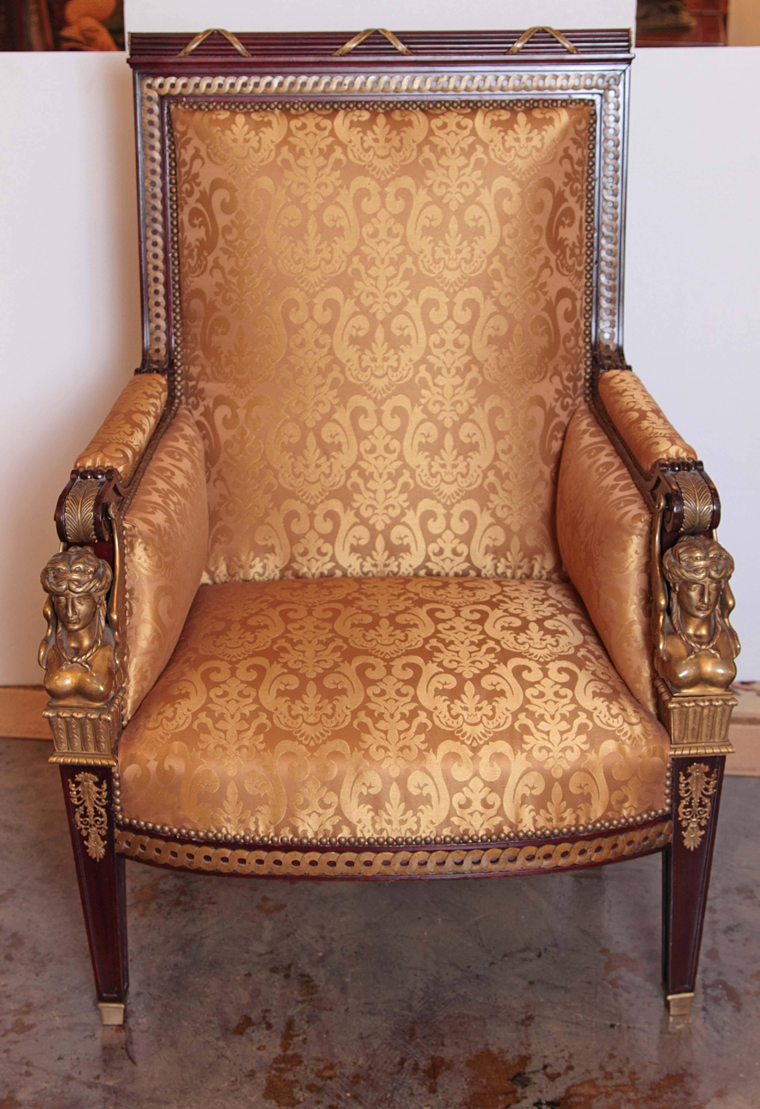19th century Empire mahogany and gilt bronze mounted bergere. Oversized beautiful large-scale bergère with gilt bronze female heads on the arms.