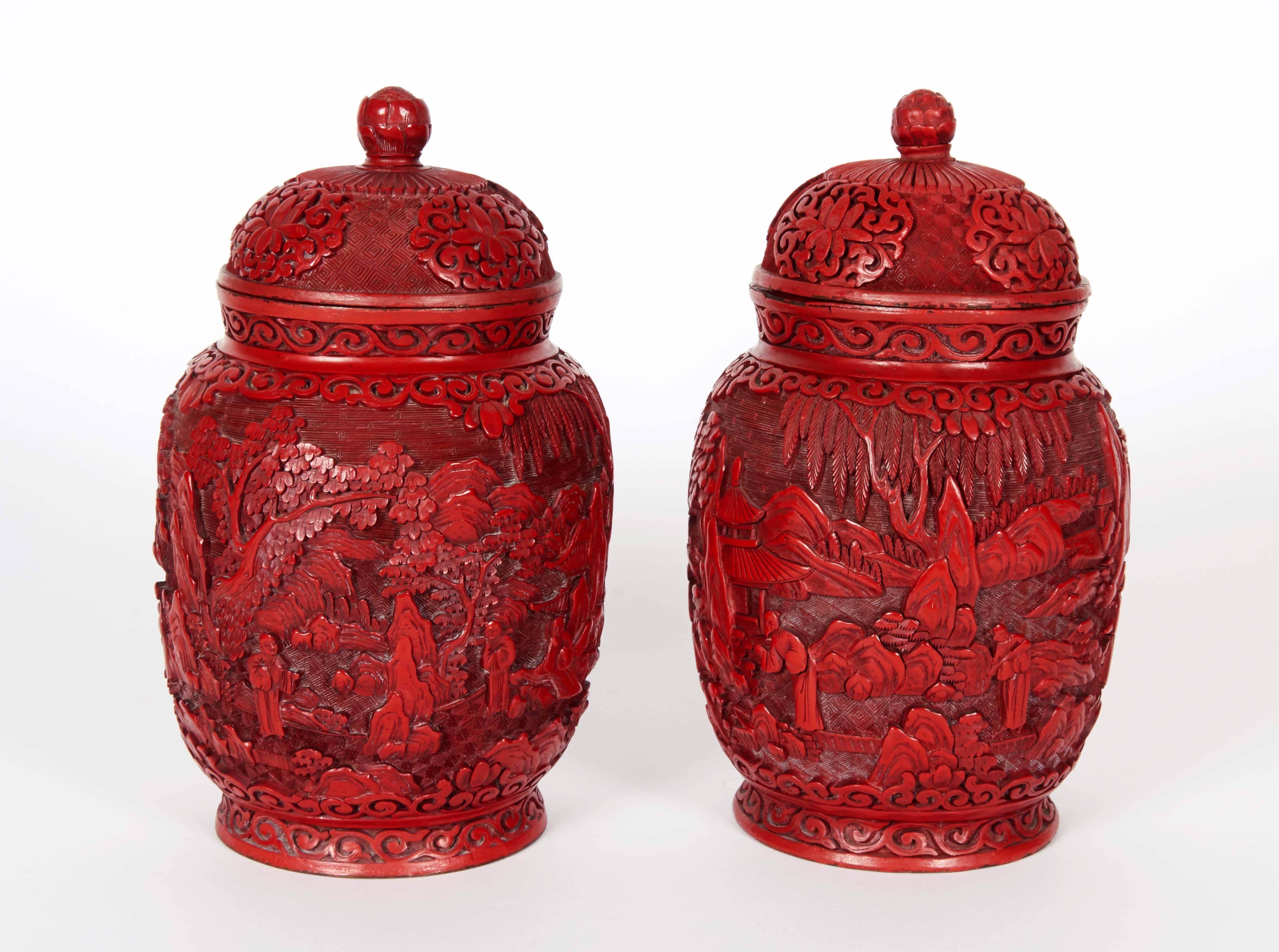A pair of antique Chinese cinnabar lacquered vases and covers.