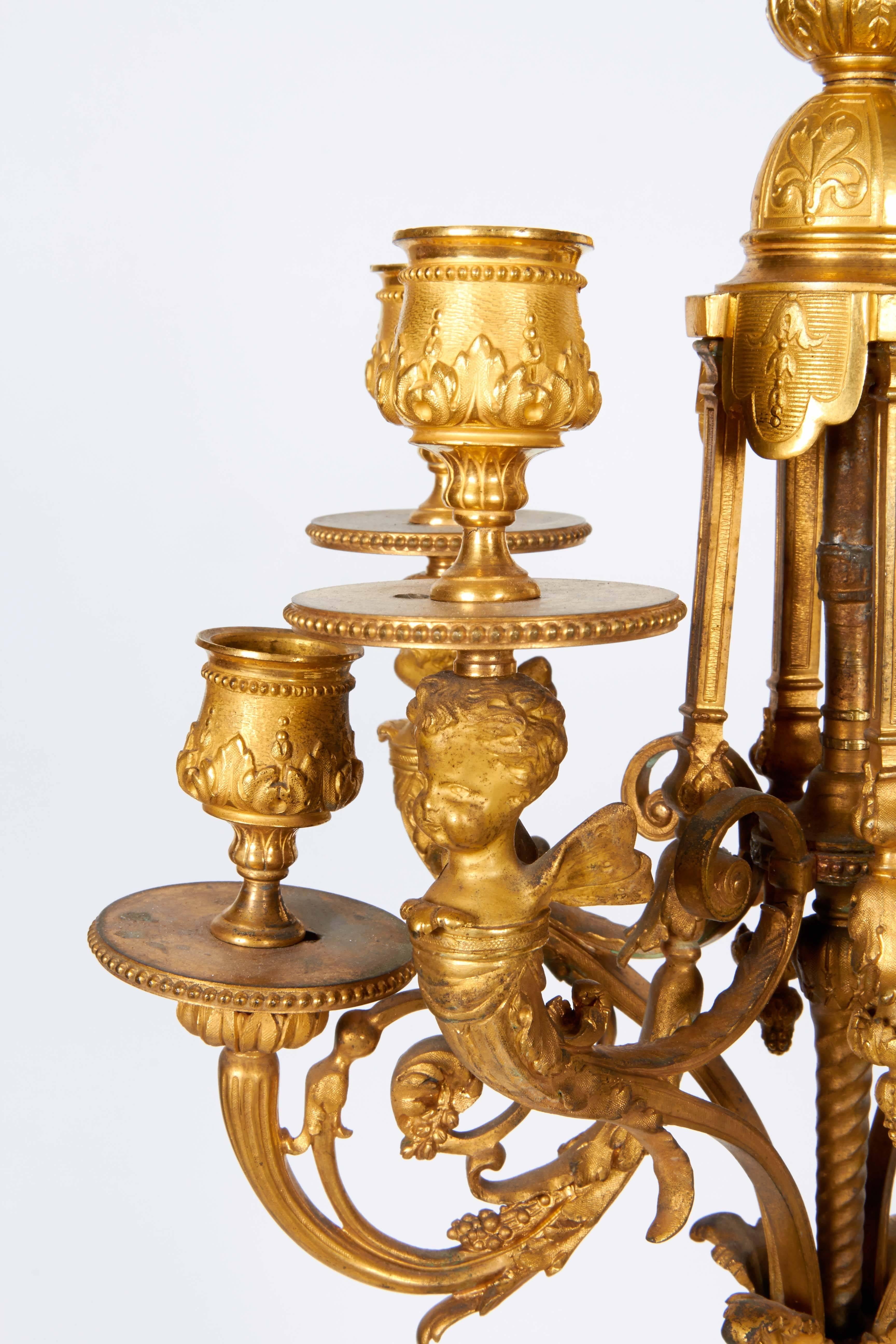 Pair of French ormolu gilt bronze candelabra with winged cherubs.

Signed MM on some bronzes.

.