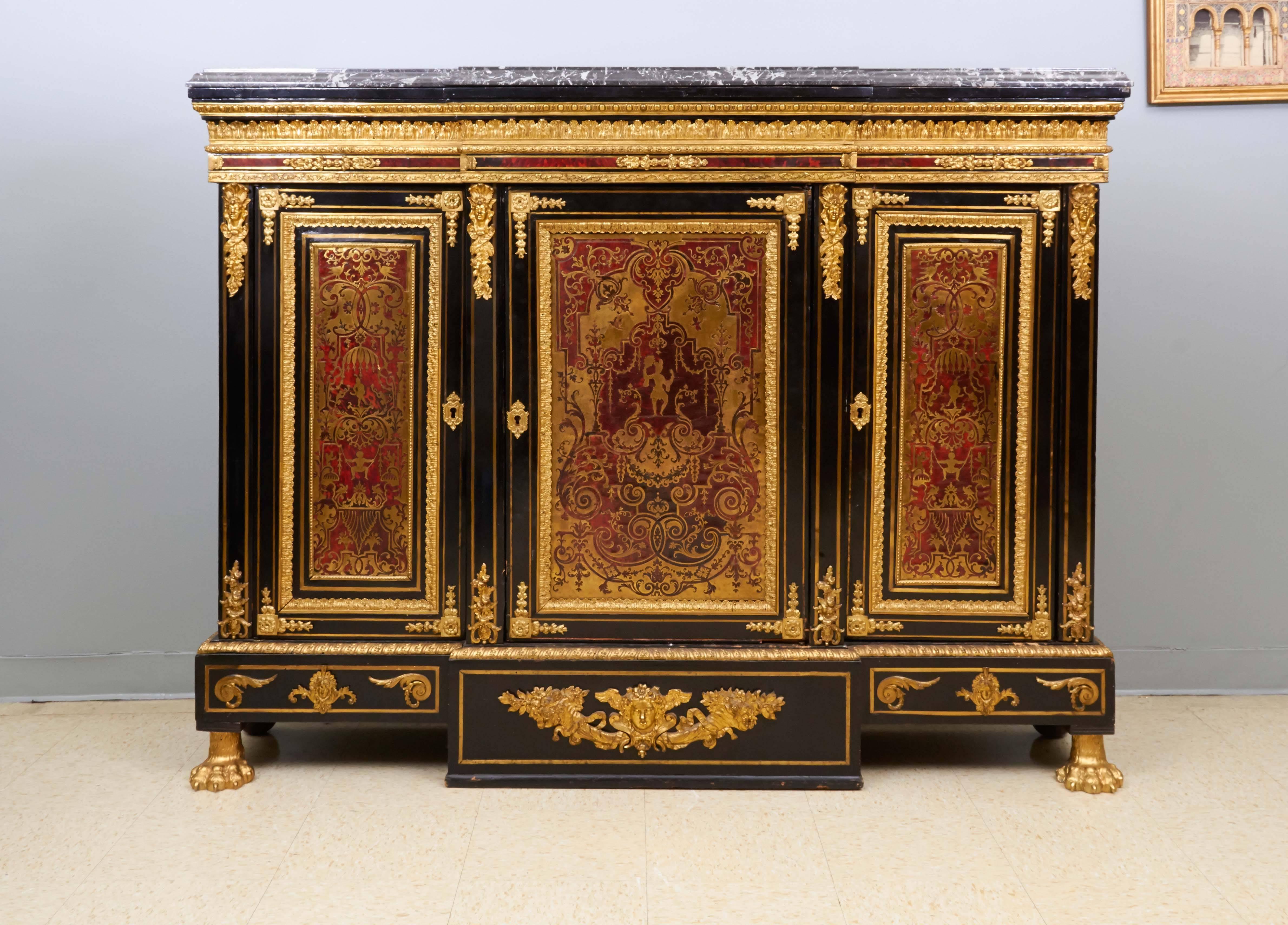 Napoleon III Ormolu-Mounted Boulle Marquetry Marble-Top Commode Cabinet

The panels in the manner of Nicolas Sageot and possibly early 18th century.

Of breakfront outline, the petit antique marble top with moulded edge above three doors, each inset