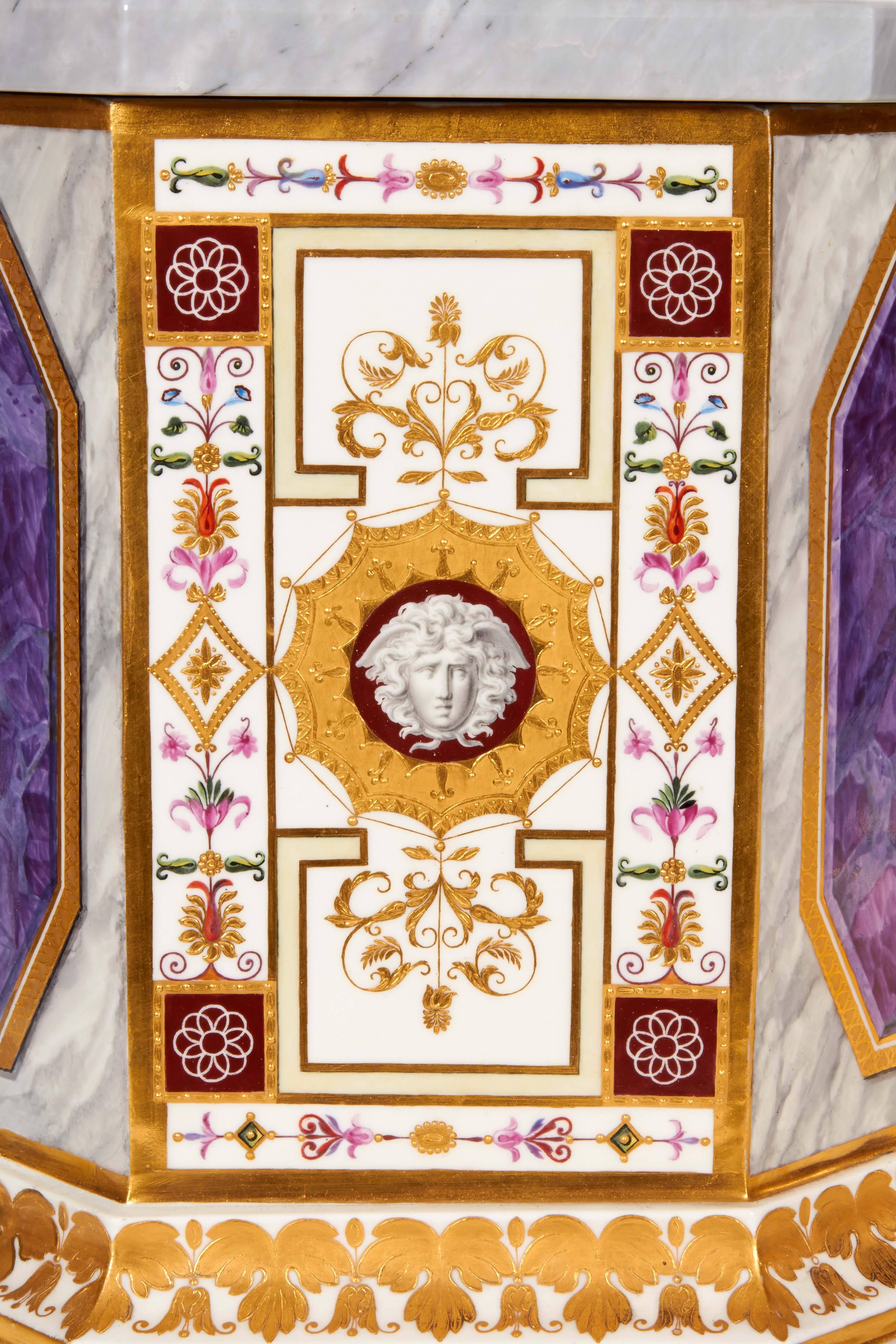 One with impressed date code for 1800 and P.
Each of stepped octagonal form, the sides alternating either faux amethyst canted rectangular panels within raised gilt surrounds on a faux marble ground, or panels centering grisaille winged Hermes