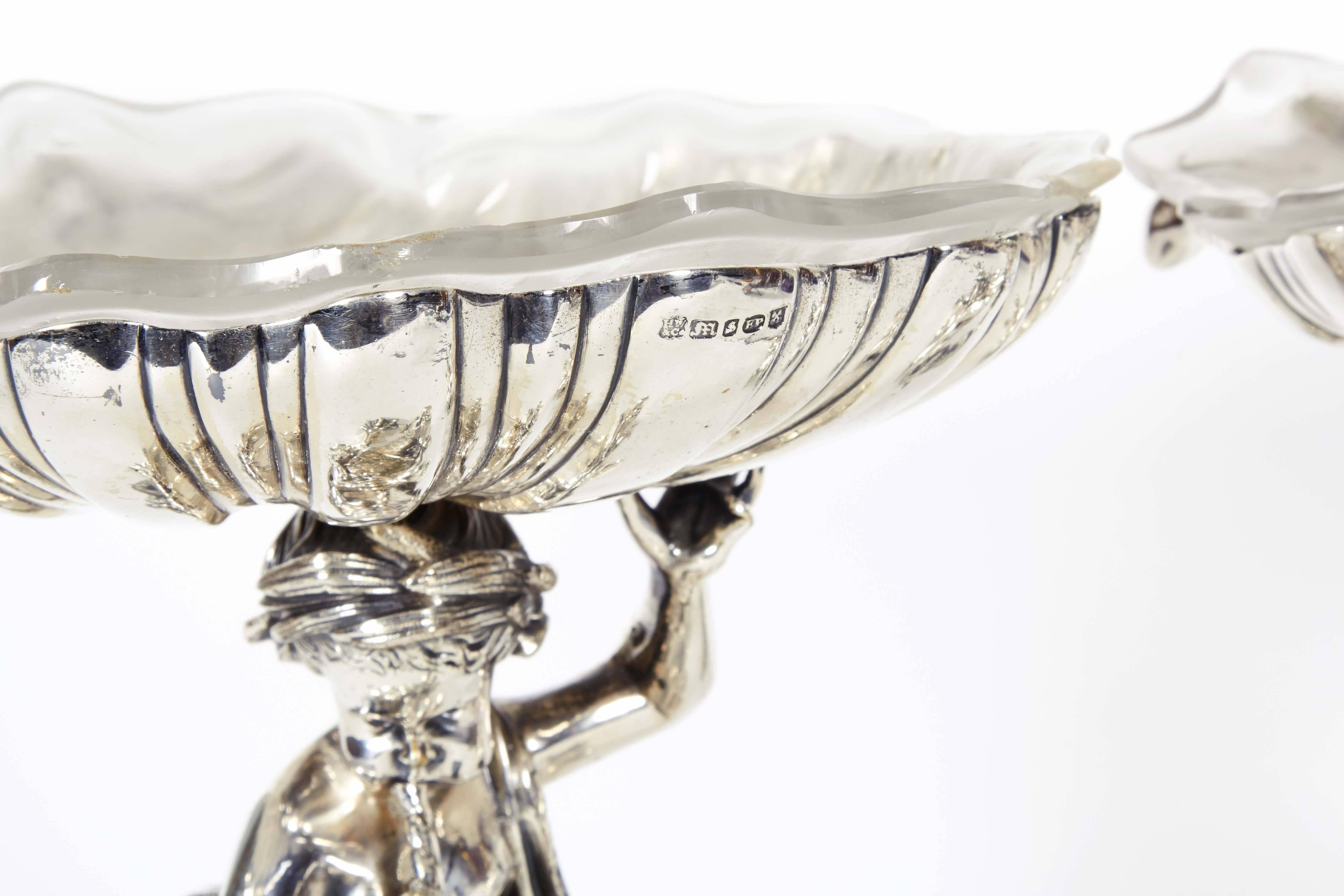 A very fine pair of English silver plated bronze and frosted glass tazza with cherubs / putti and sea dragons.

Original glass.

Henry Wilkinson & Co, Sheffield. Marked.

Henry Wilkinson & Co was involved in the manufacture of Old Sheffield