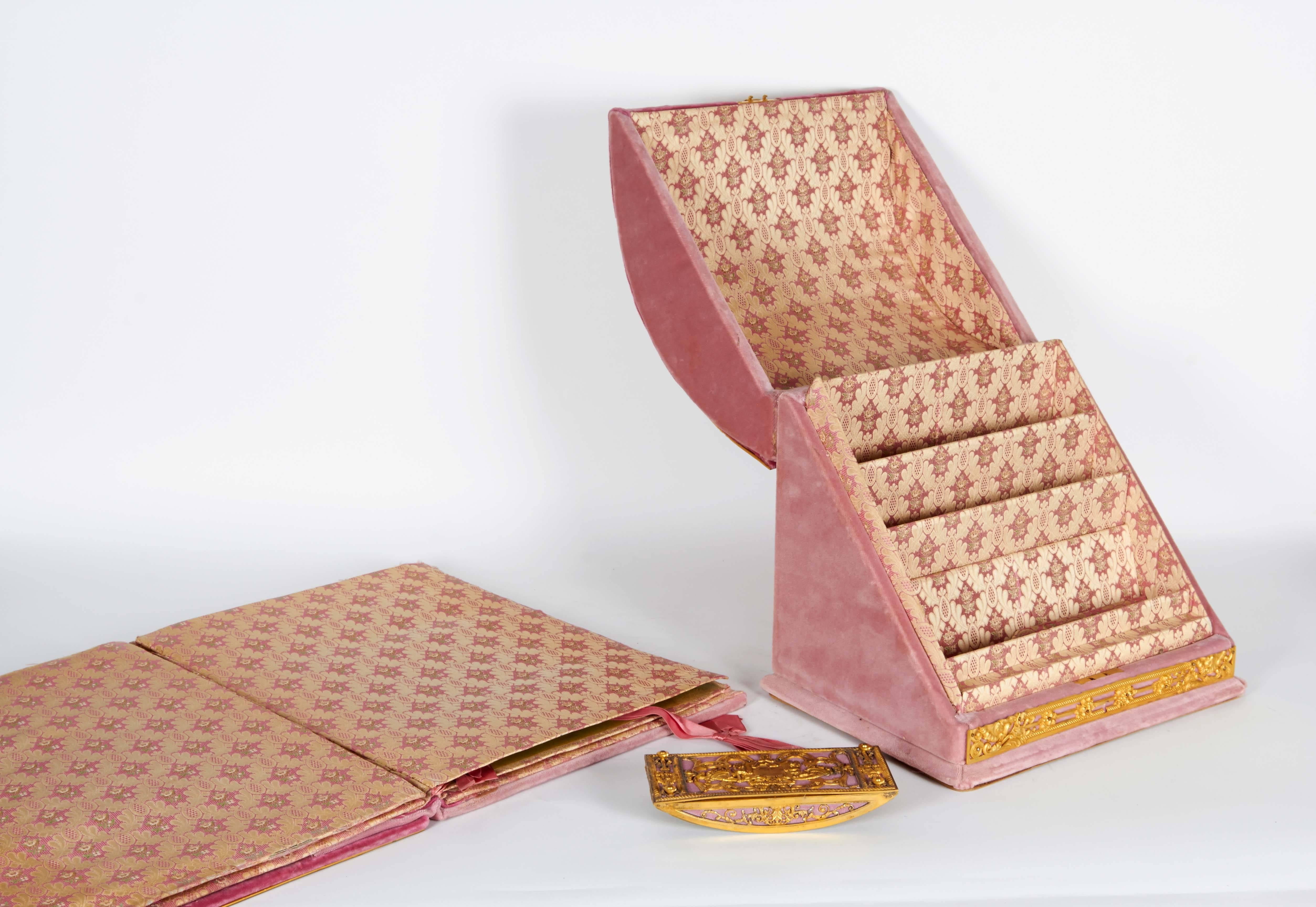 A very fine three-piece gilt bronze-mounted pink velvet desk set by Edward F. Caldwell & Co.

Comprising of a folio, ink blotter and letter box.

Folio: 16