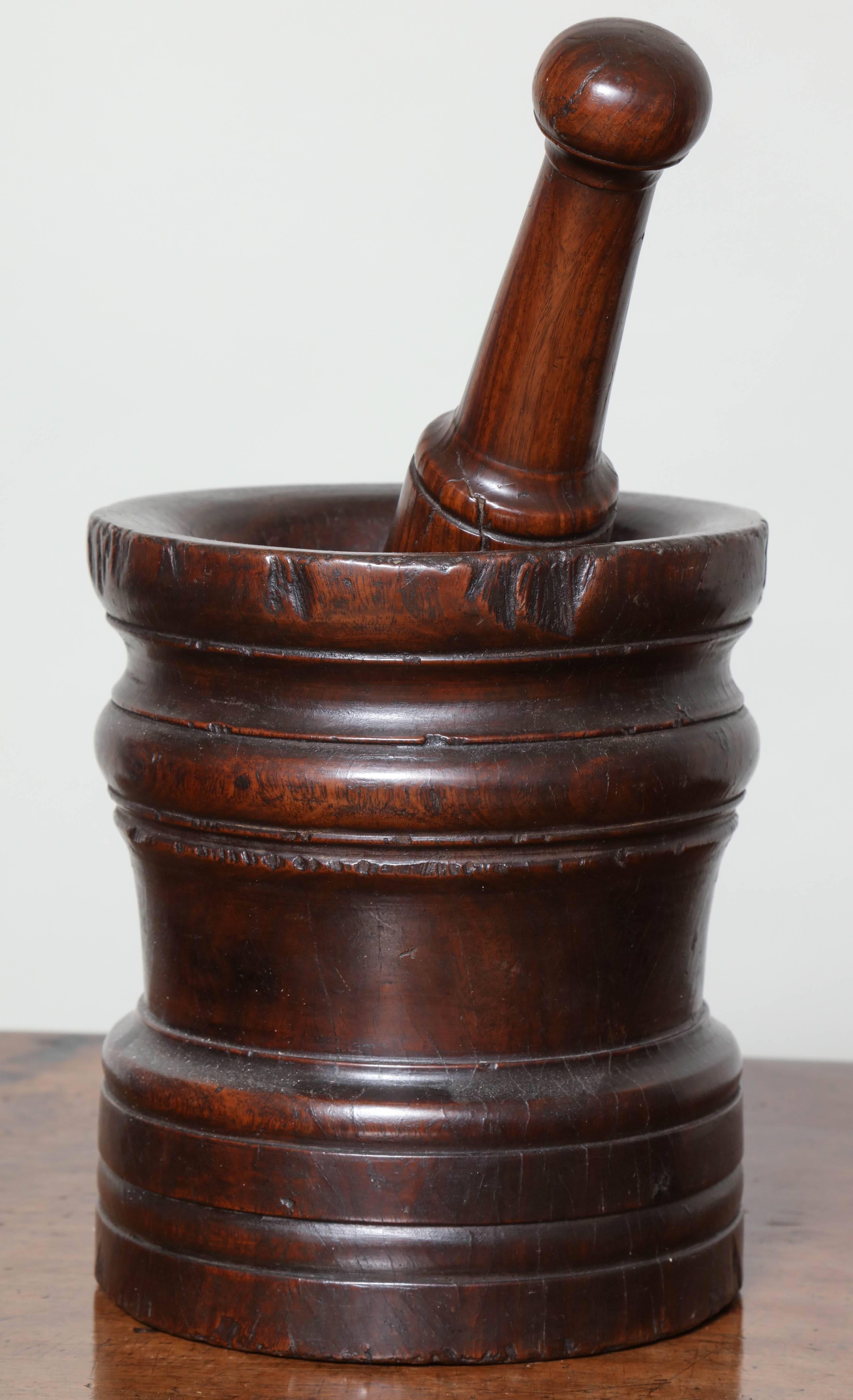 Good 18th century English turned lignum vitae mortar and pestle retaining great color and of pleasing proportions.