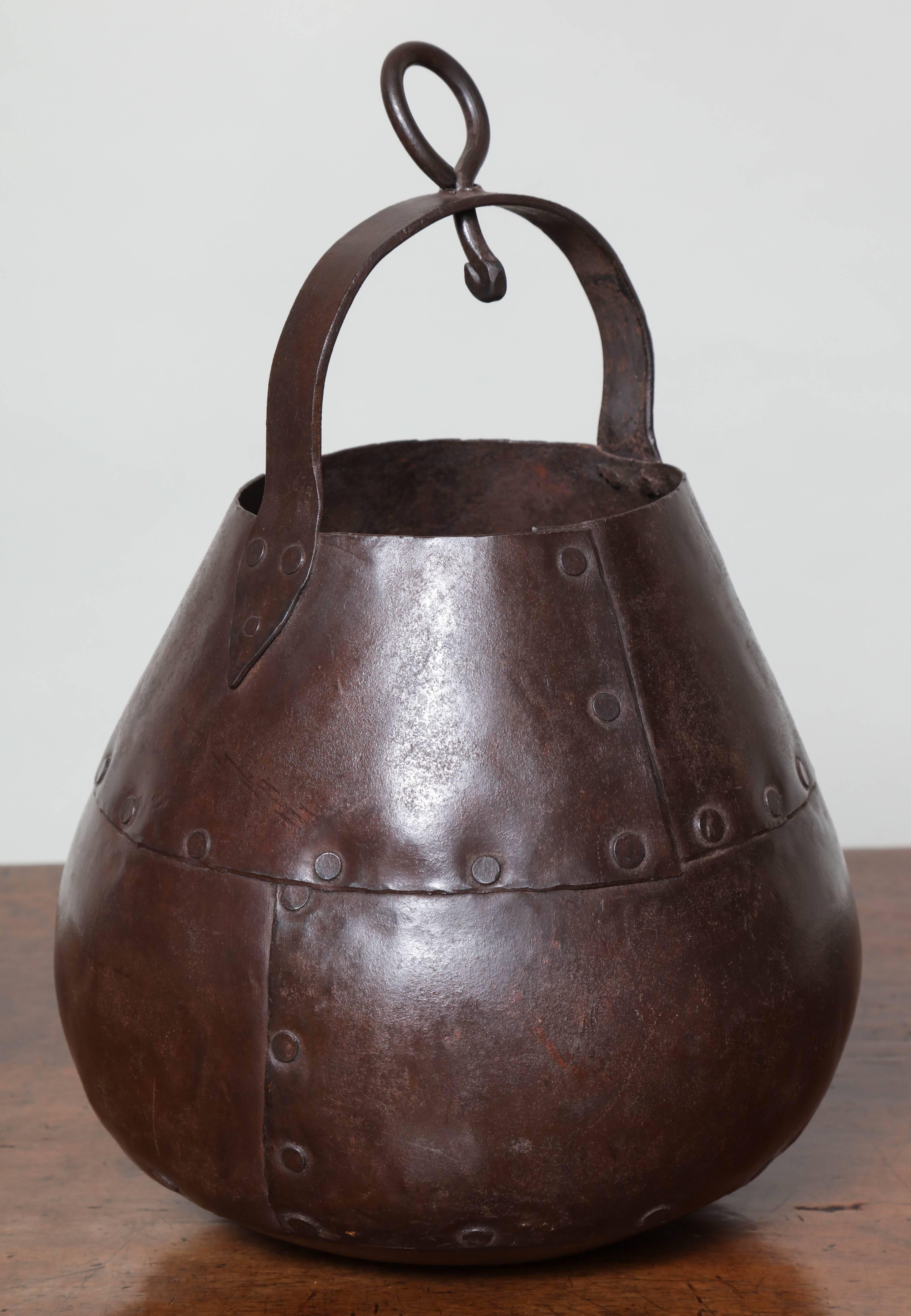 Arts and Crafts period hanging pear shaped pot with hand riveted seams, beaten surface and great color.