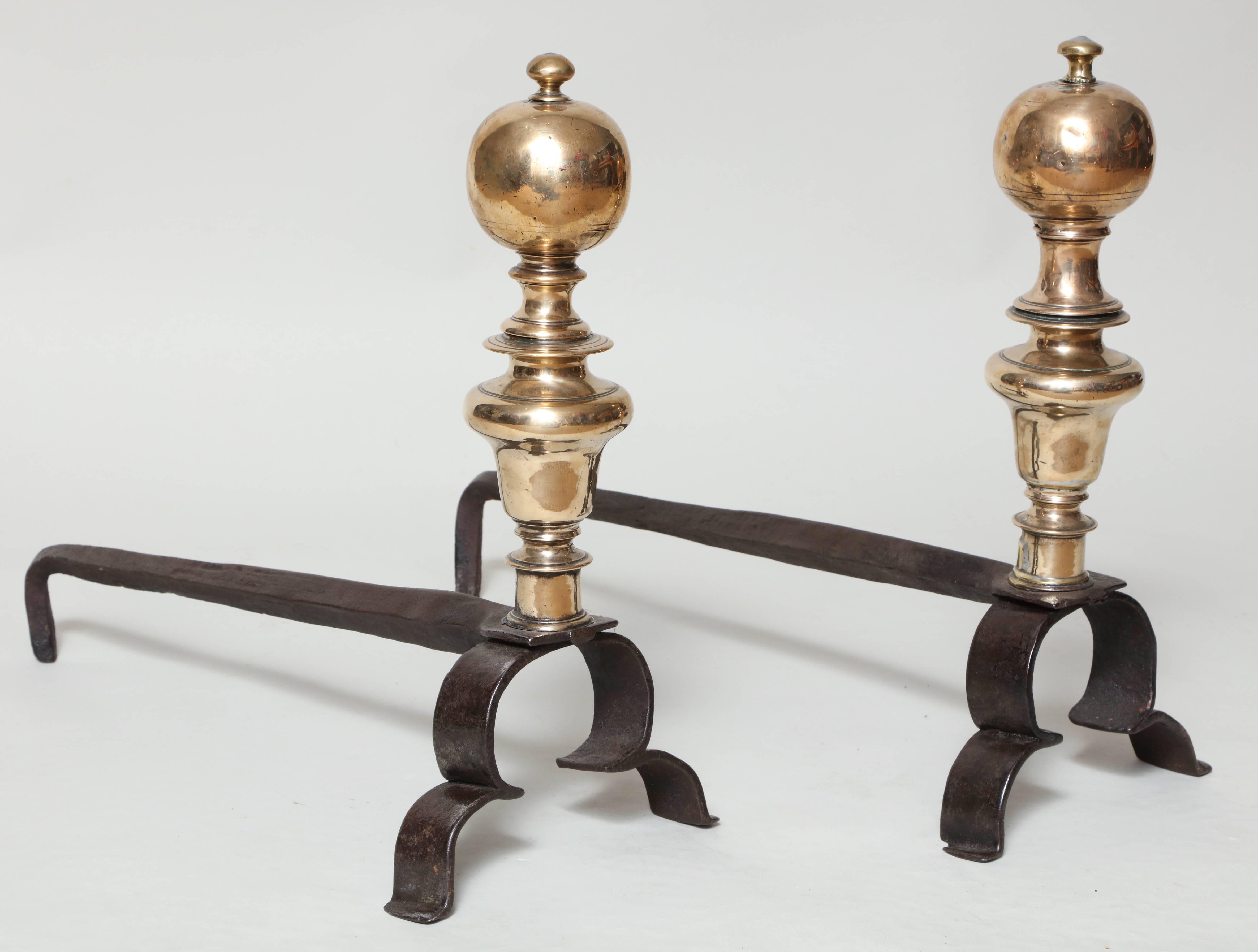 Good pair of Flemish baroque bronze and wrought iron andirons with large ball finials over balustrade turned shafts on simple double scrolled wrought iron legs.