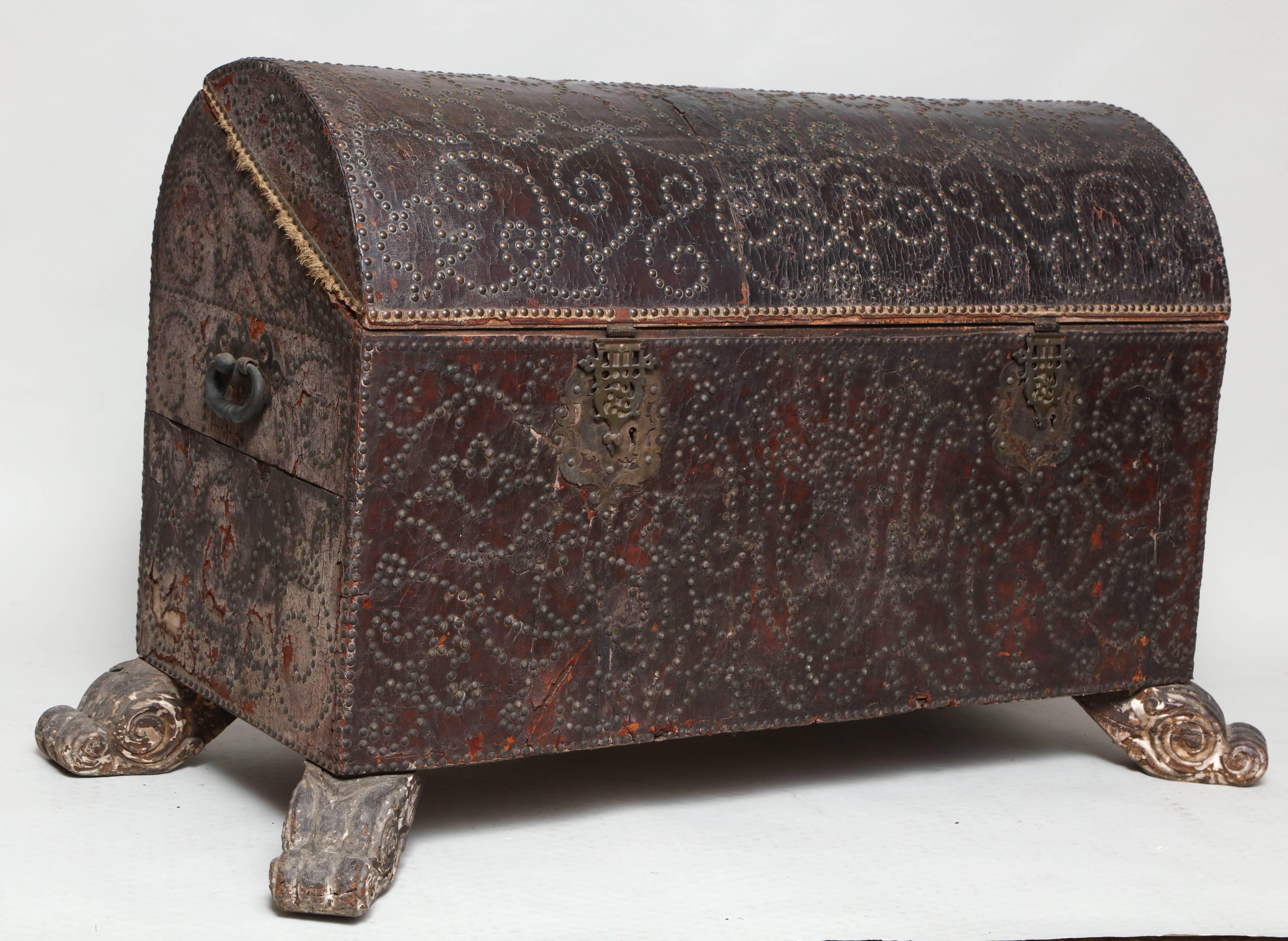 Very good Spanish 18th century studded leather chest, the domed lit with Arabesque design stud work, the front with two pierced brass clasps and escutcheons with original iron locks, the front also with Arabesque stud work, standing on original paw