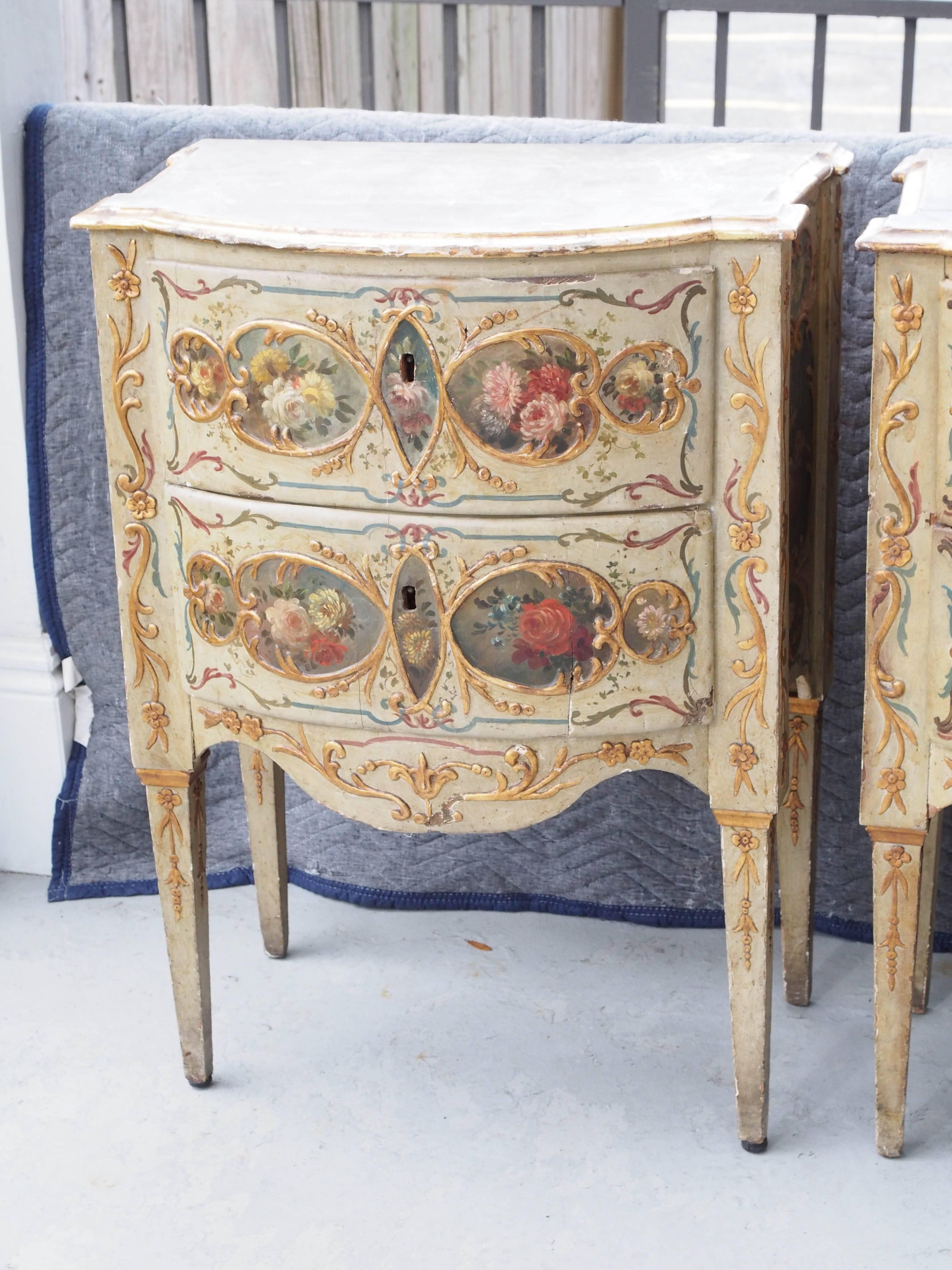 Pair of early 19th century Venetian painted commodini. Painted with medallions of floral motif with foliate decoration surrounding. Faux marble tops.