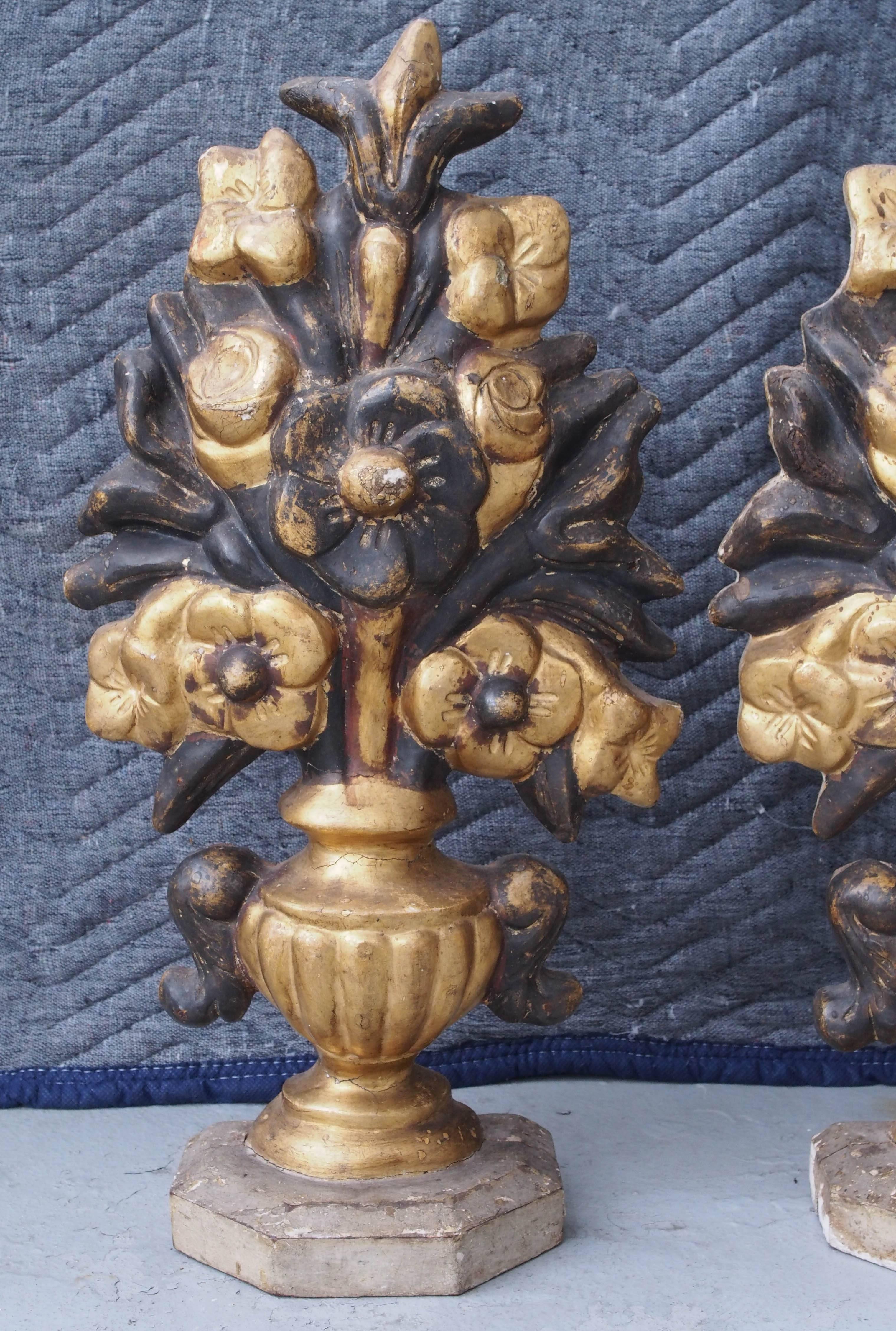 Pair of Italian carved giltwood vases with flowers. Single sided with original gilt finish.
 