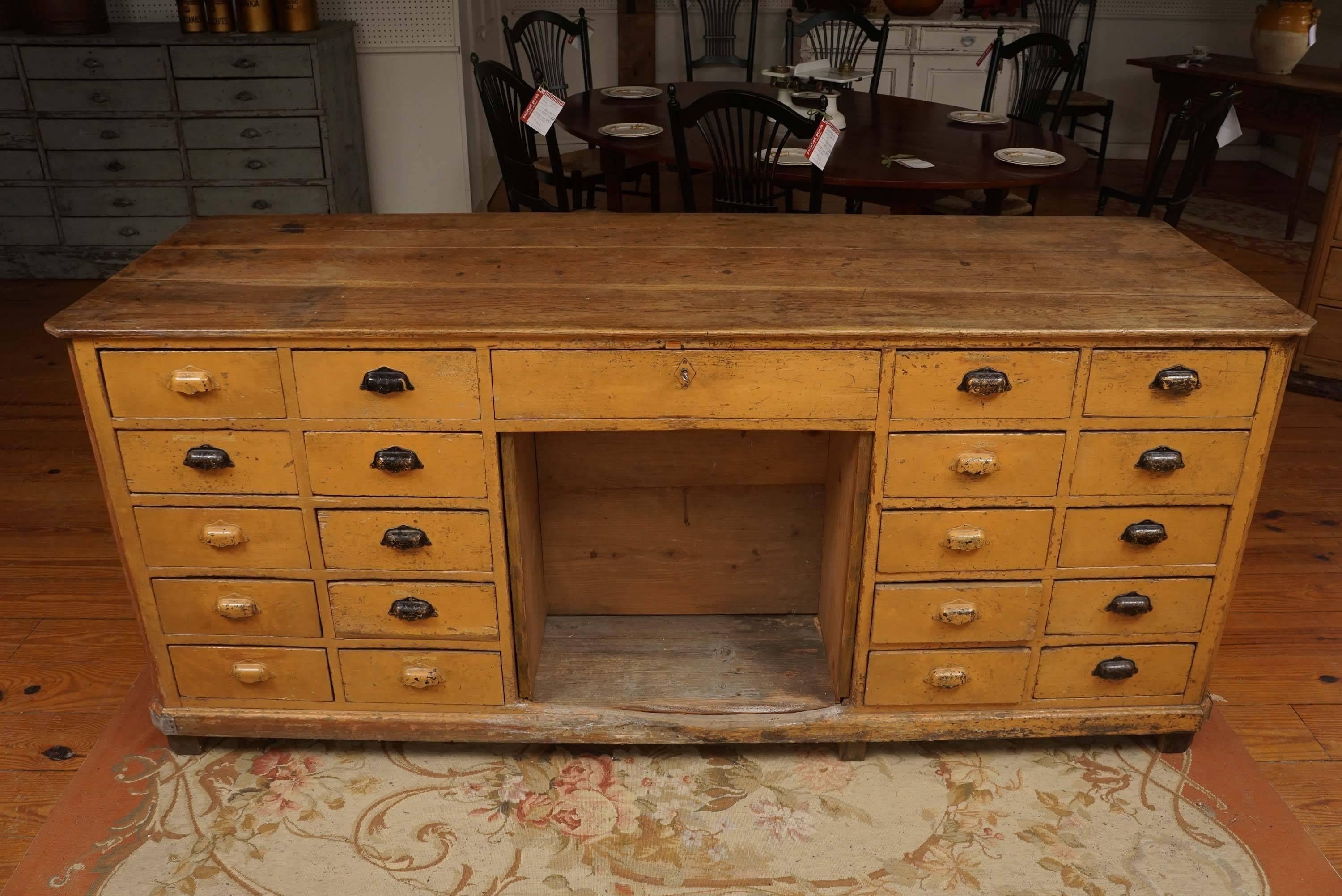This is one of the most unique pieces we have bought in several years. It has original caramel shade paint and all original hardware. There are drawers on both sides of this One of a Kind hardware store counter from the south of France. There is a