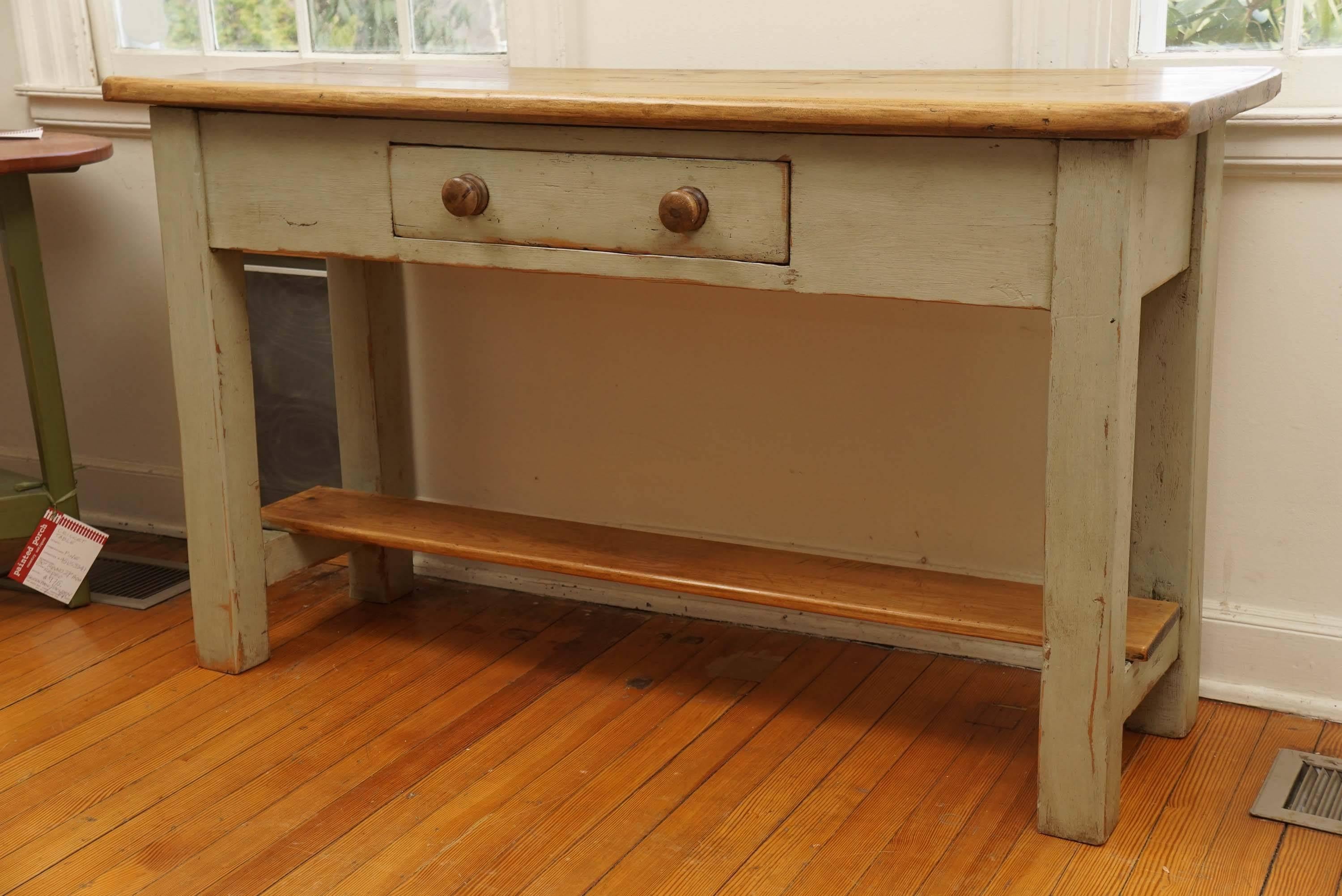 870 - This Irish server has a pine pot board shelf and a wonderful pine top. Painted in newer French grey paint this is a very nice sized serving table with a large drawer and two wooden pulls. We love Irish furniture at Painted Porch.