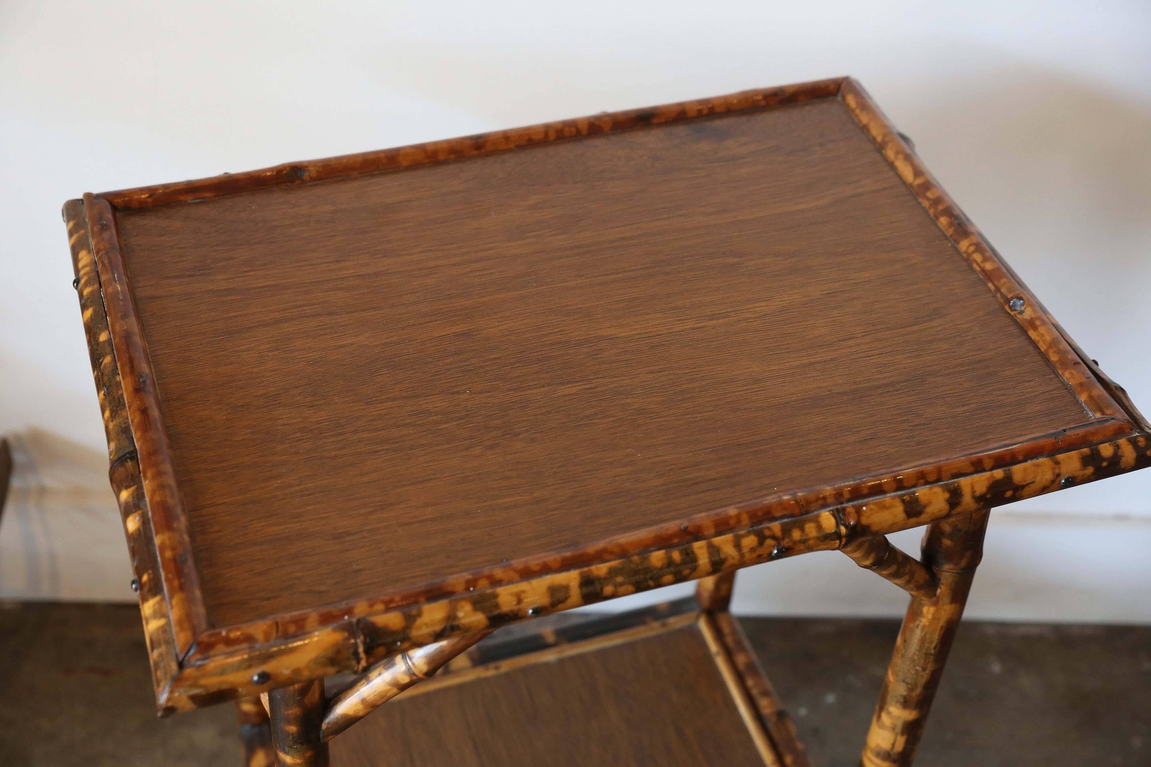 19th century scorched bamboo tortoise shell colored table with two levels.