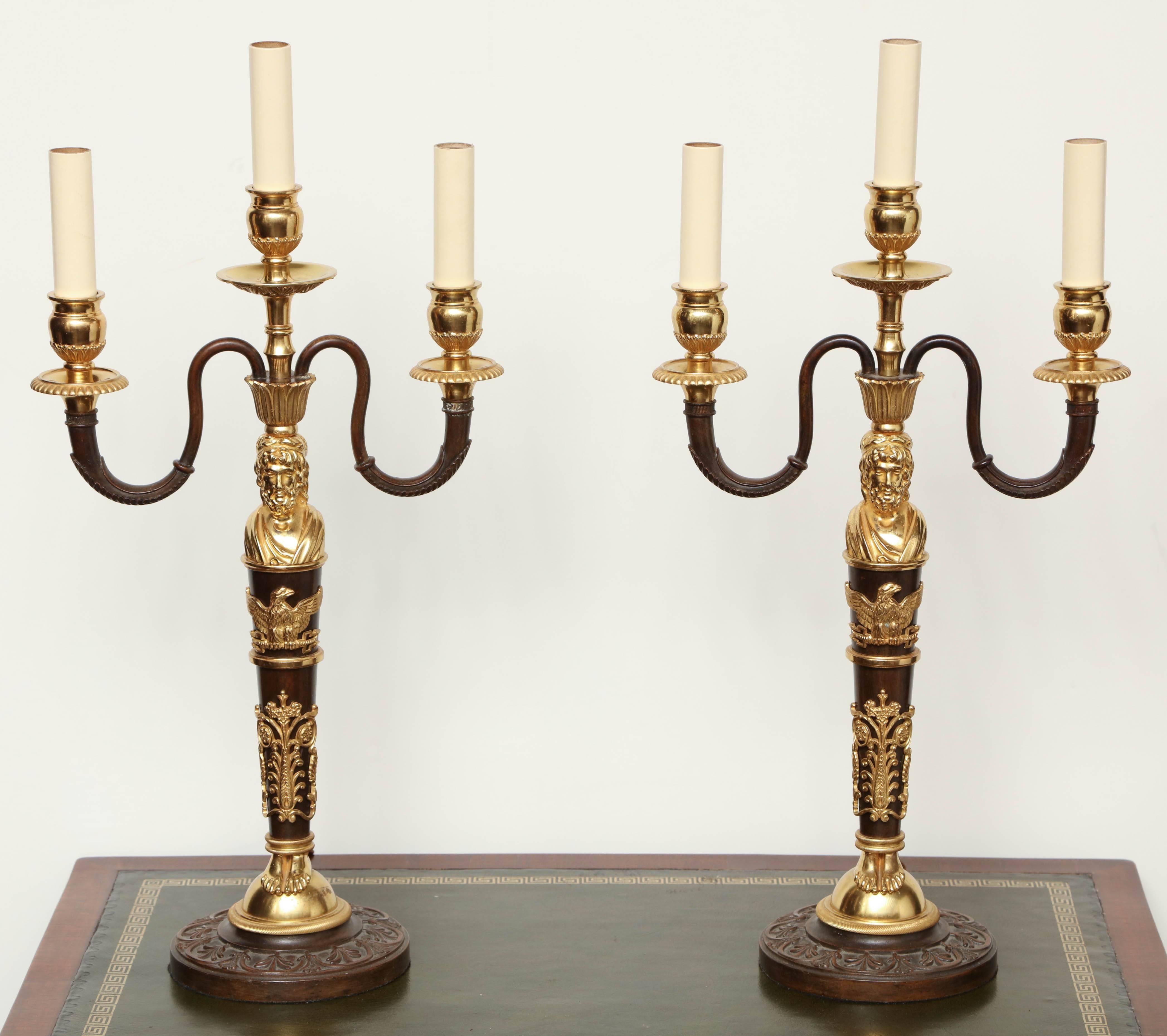 Pair of bronze and gilt bronze three-branch candelabra converted to lamps.