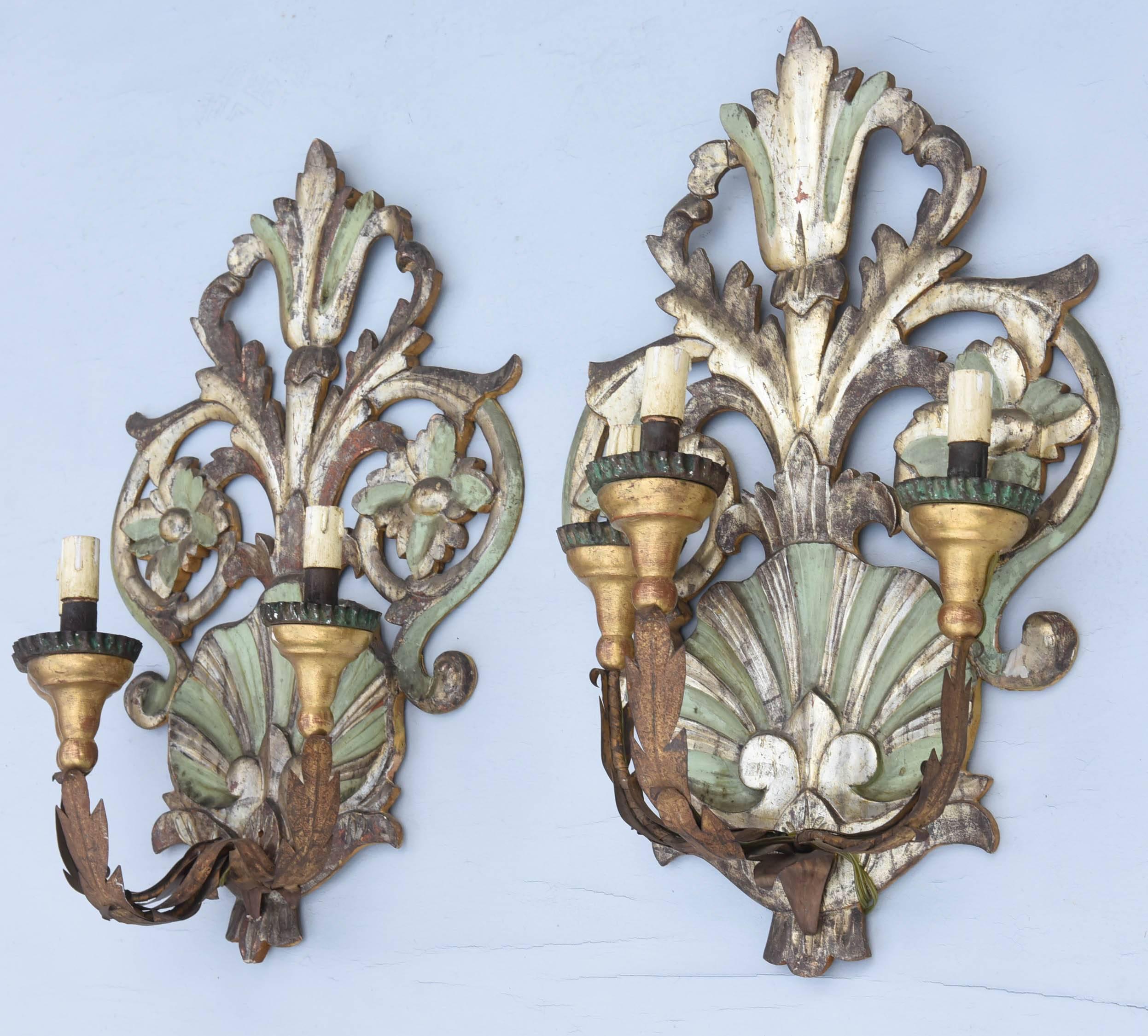Pair of sconces, painted and parcel silver gilt finish, each having a pierced backpate carved with a scallop shell, surmounted by pierced, scrolling, foliate flourish, extruding a trio of C-scroll candlearms, decorated with iron acanthus leaves,