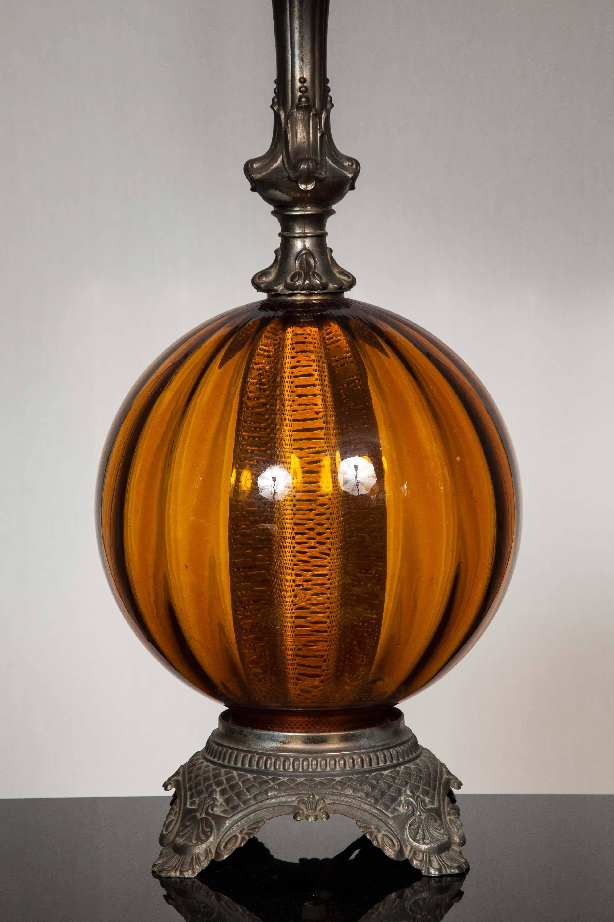 With its beautifully curved shape the warm tones of amber is gorgeously contrasted by the pale blue modern silk shade.

Total height: 94 cm.

Base: Height 68 cm. 

Shade: Height 54 cm, width 24 cm.
