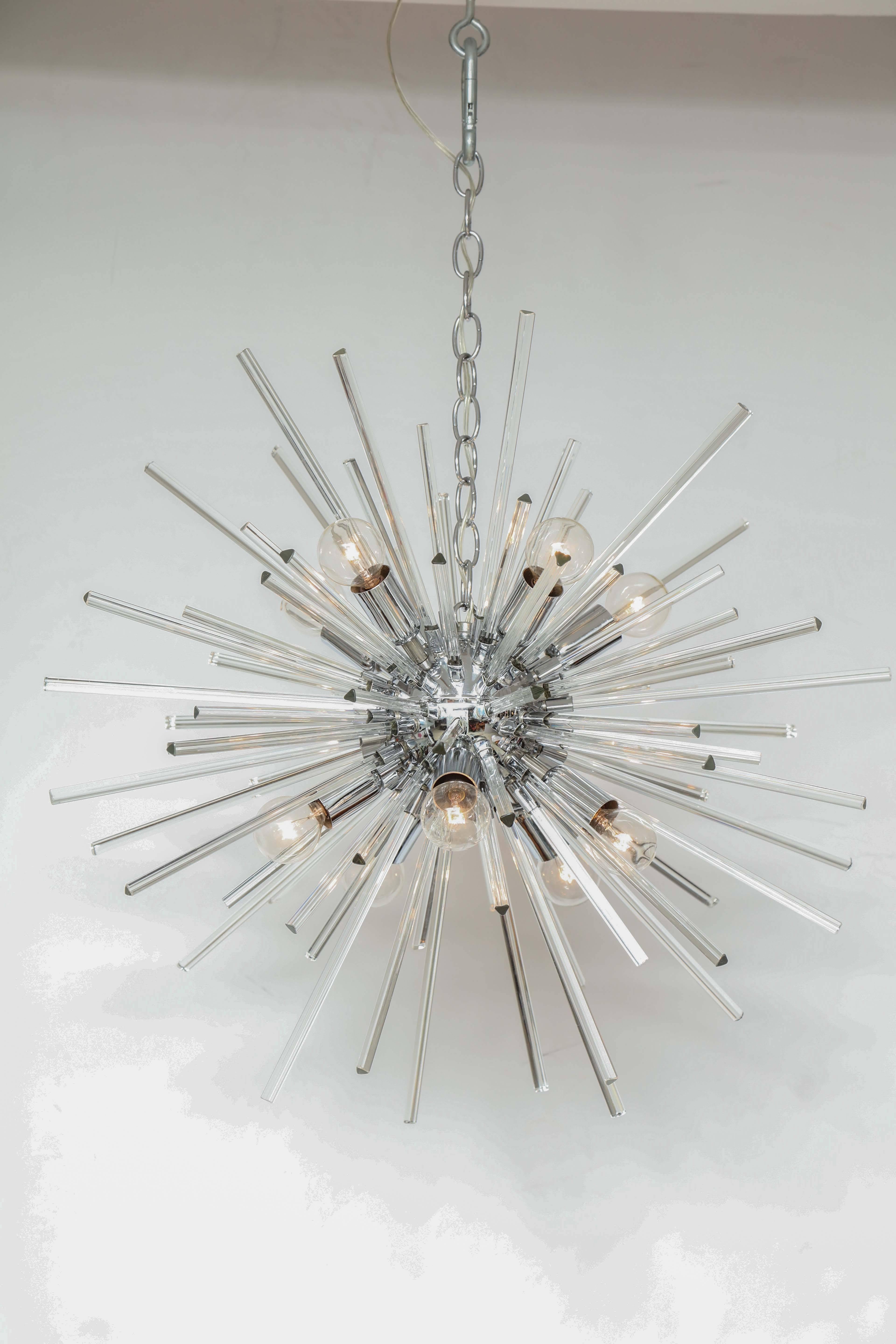 Italian sputnik chandelier attributed to Venini with clear Murano glass bar prisms branching out of a chrome frame with 10 lights. 
