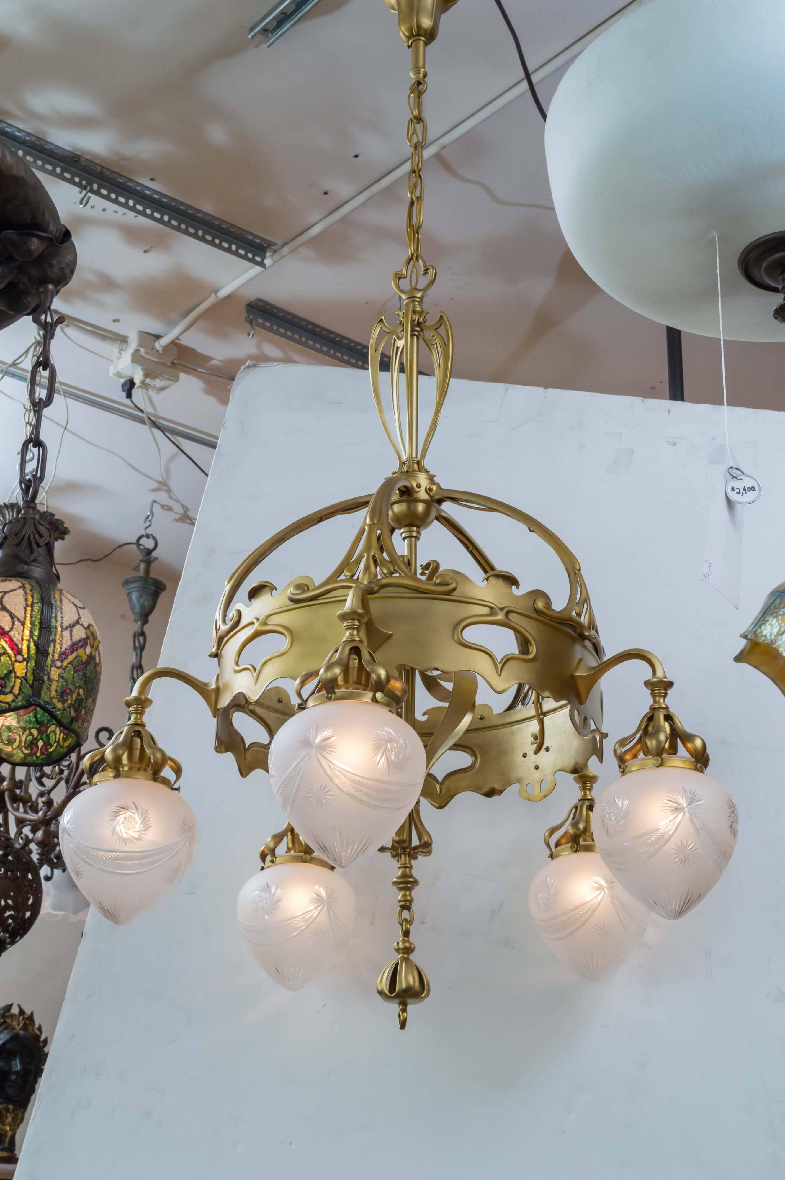 This quite incredible Art Nouveau chandelier has all the characteristics that make this style a favorite of most of our clients. Definitely one of the finest examples of this style we have offered in quite a while. Sinewy lines everywhere and airy